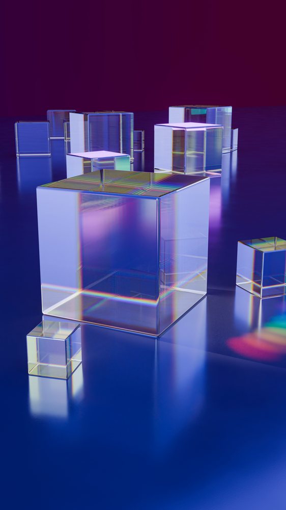 Transparent glass cubes with colorful reflections on blue surface