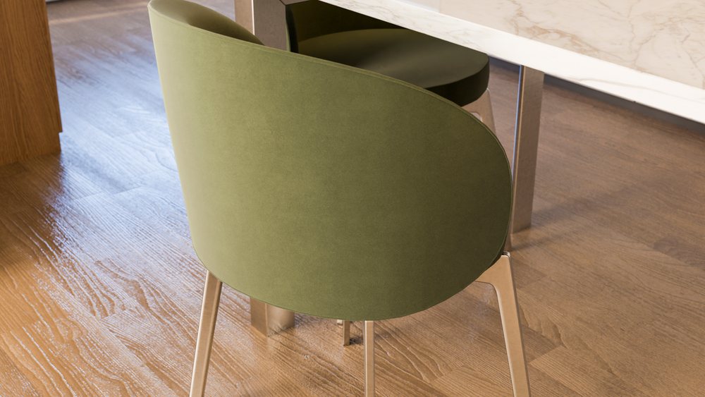 Green upholstered dining chair with metal legs near marble table