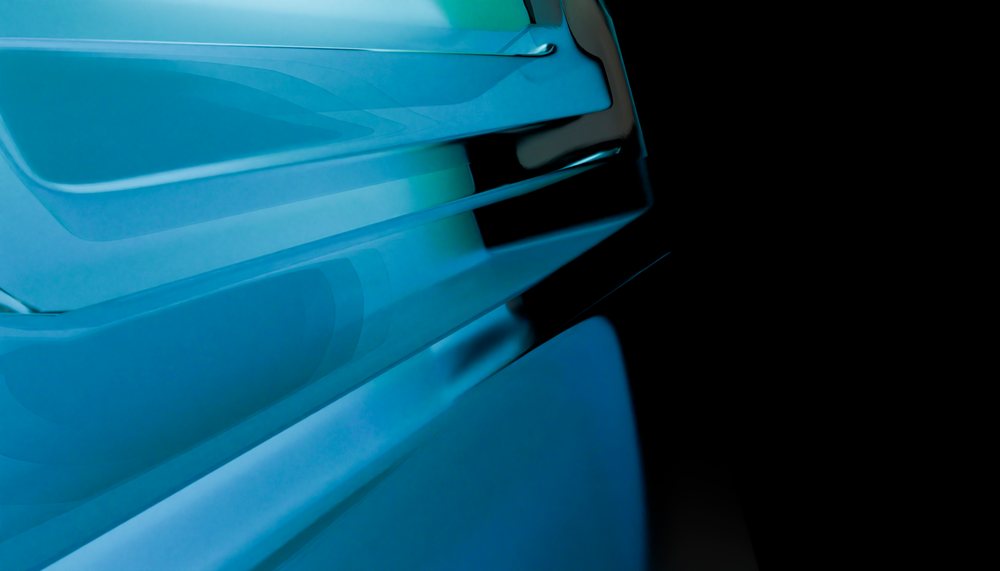 Close-up of blue abstract glass shapes with smooth reflections