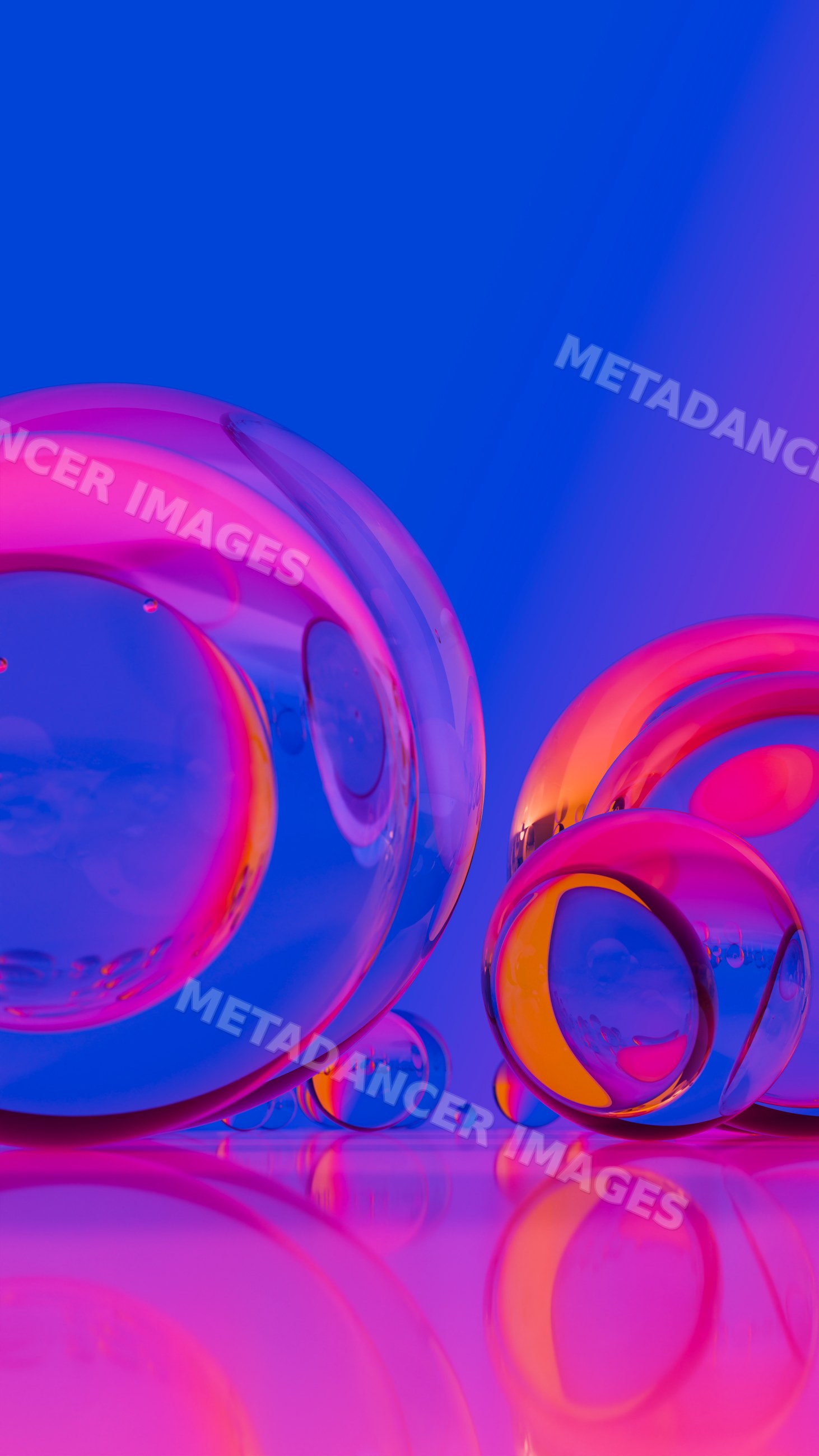 Colorful transparent glass spheres with reflections on shiny surface