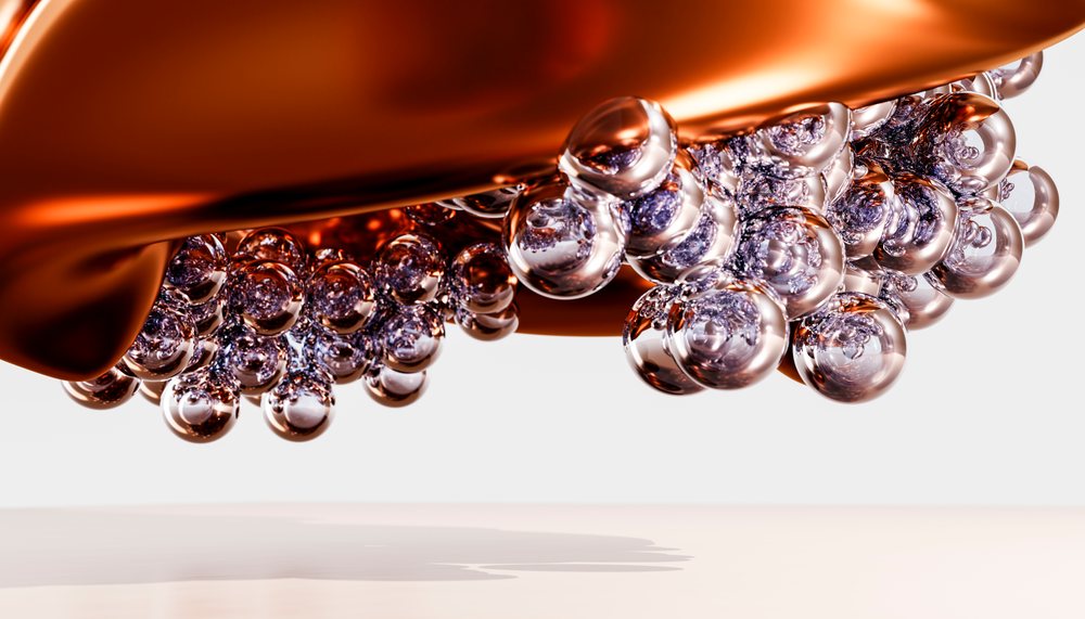 Close up of transparent bubbles on metallic copper surface