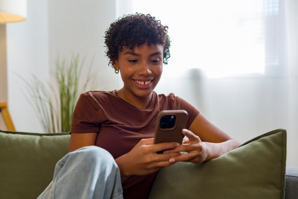 Young African American woman using smartphone