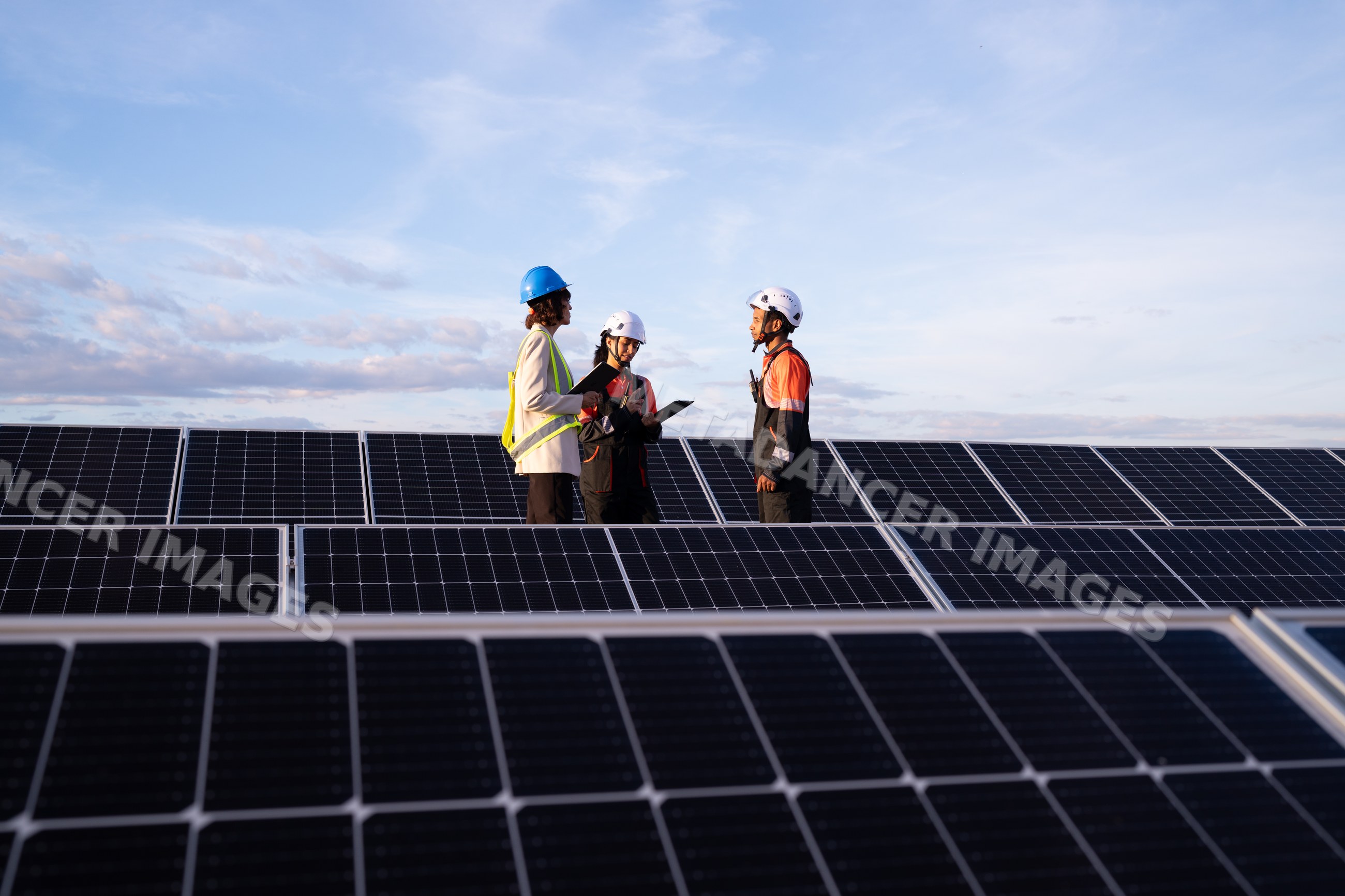 Hispanic and white workers inspecting solar panels