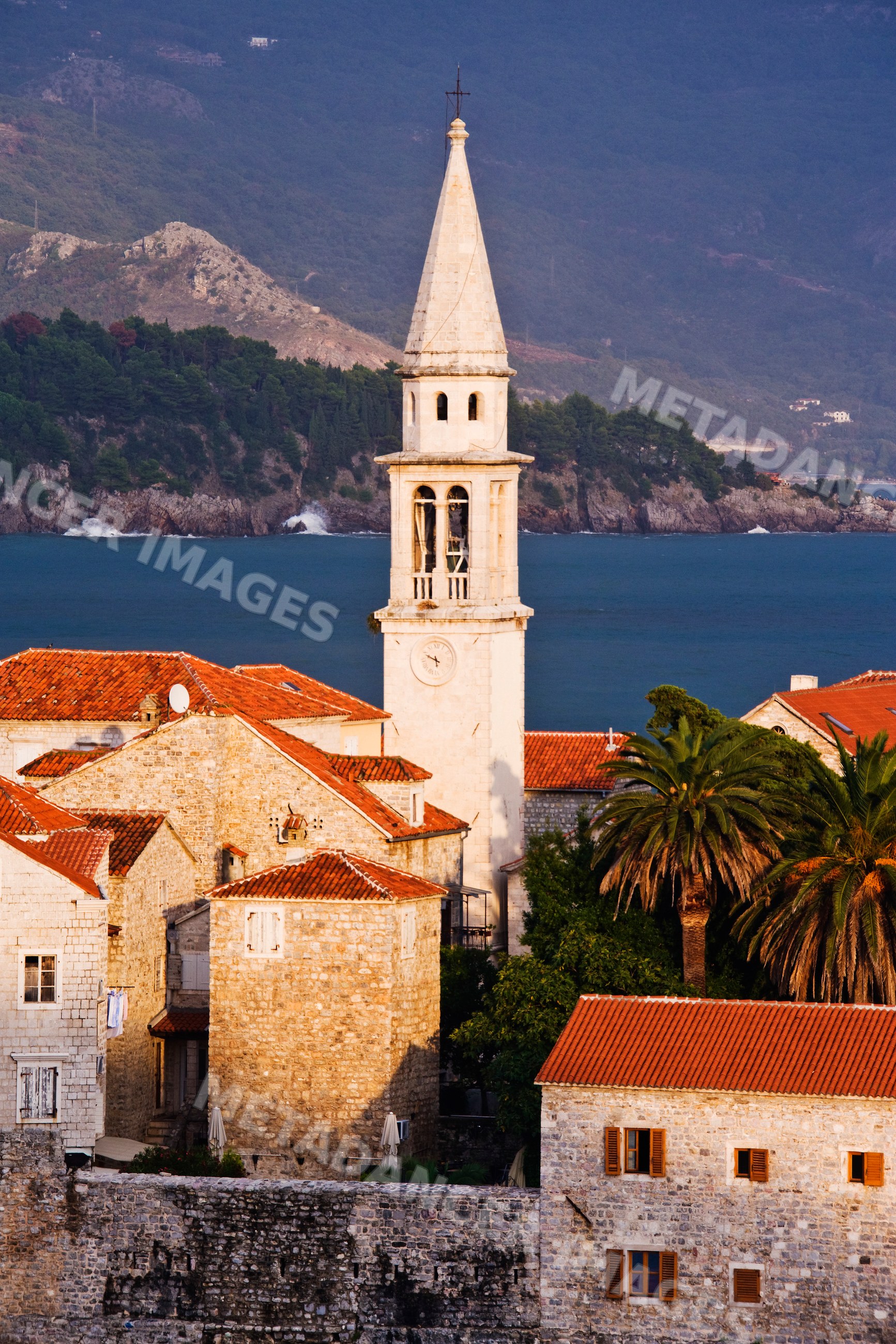 Church tower and red roofs seaside town montenegro