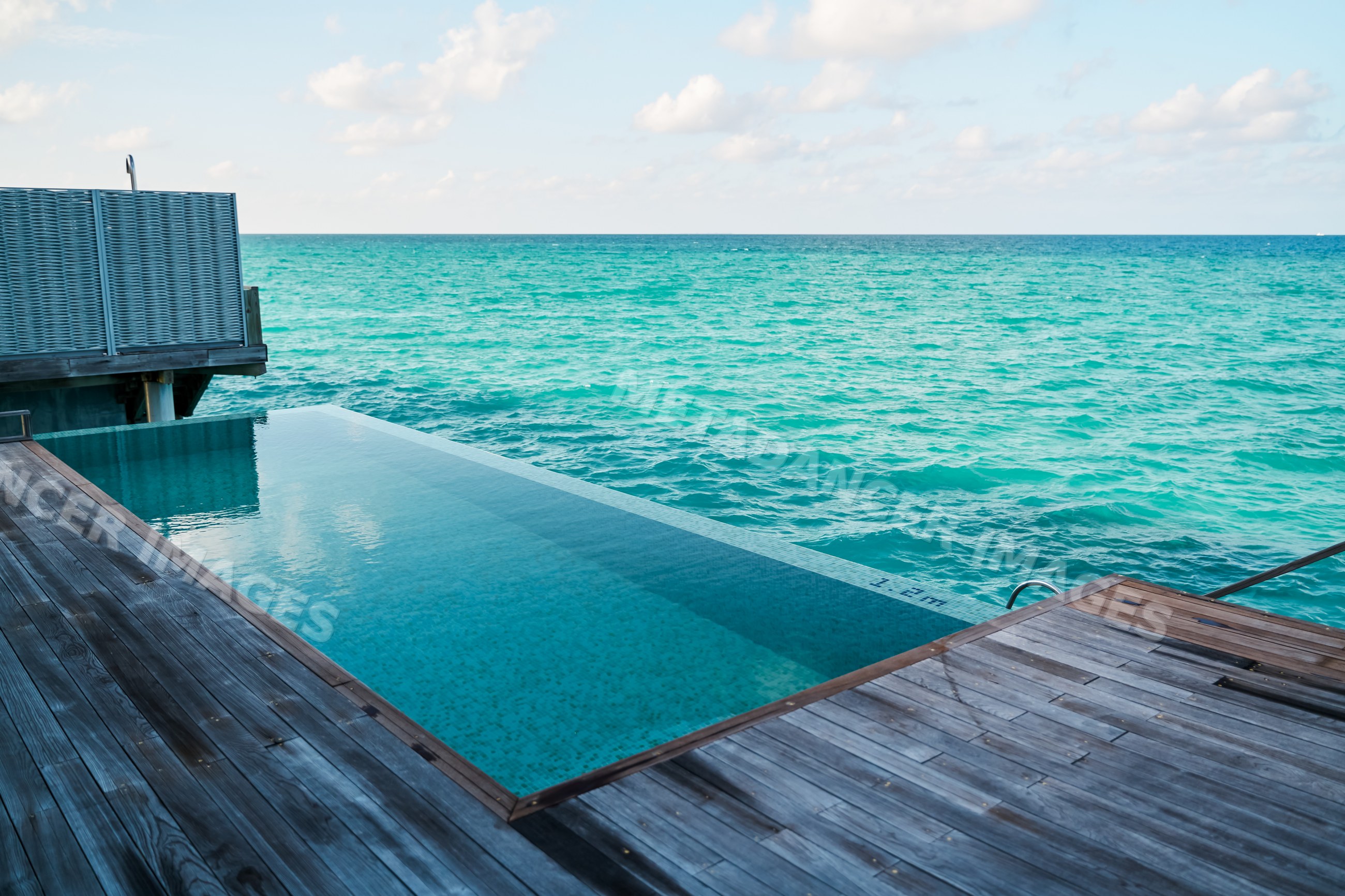 An infinity pool overlooks the turquoise ocean