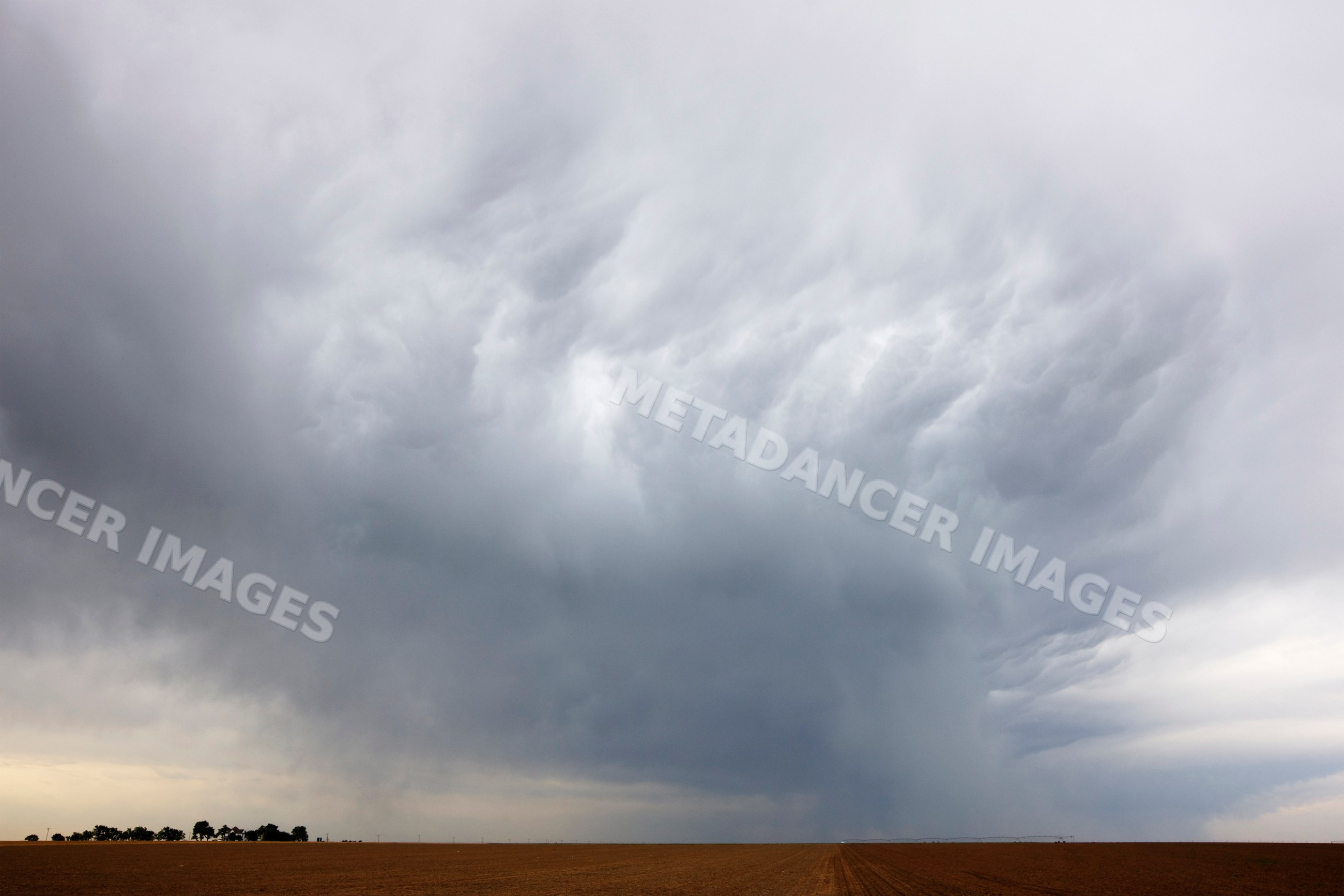 Storm clouds gather over flat field, USA