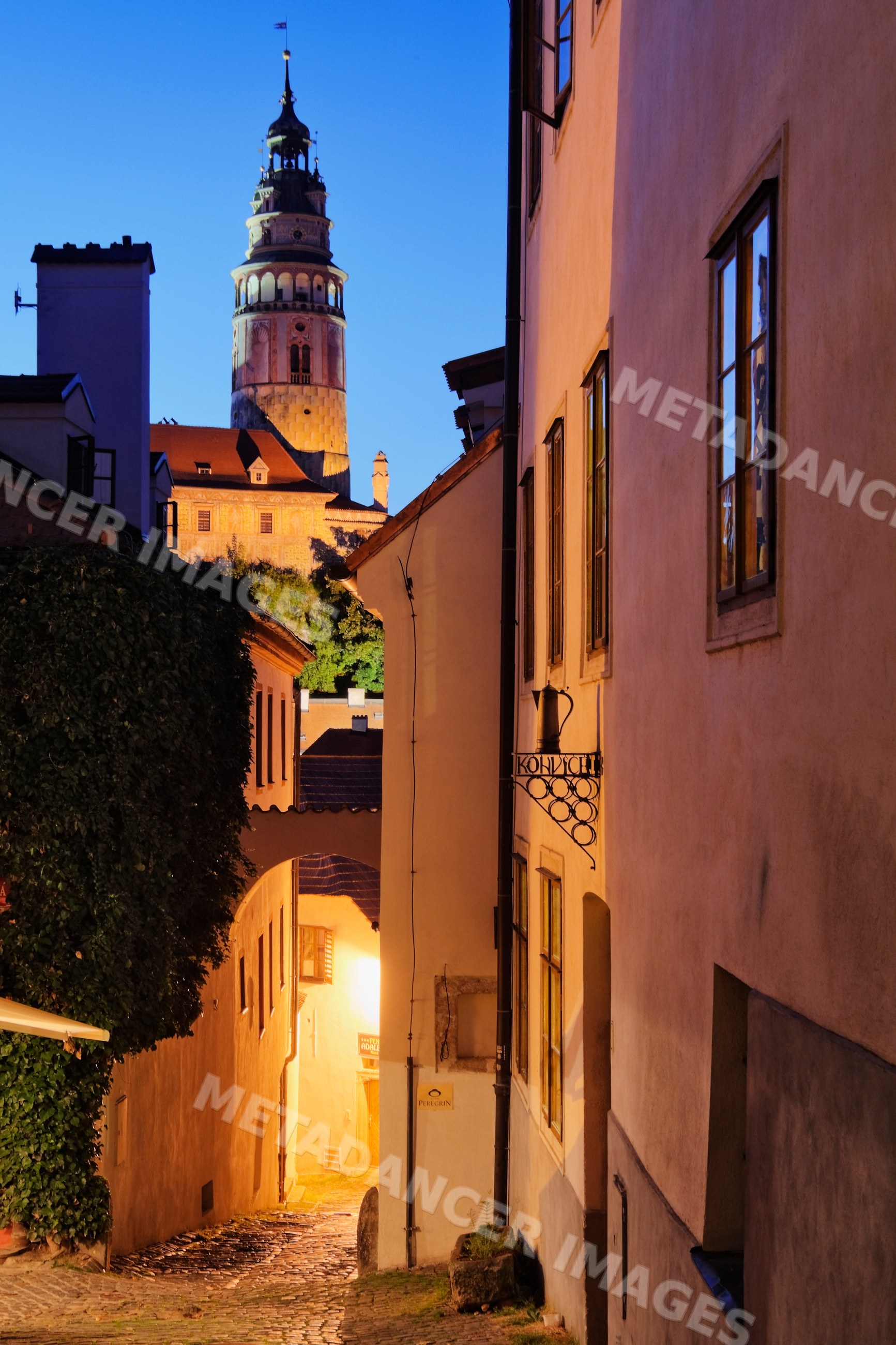 Cesky krumlov historic tower and cobblestone street at evening