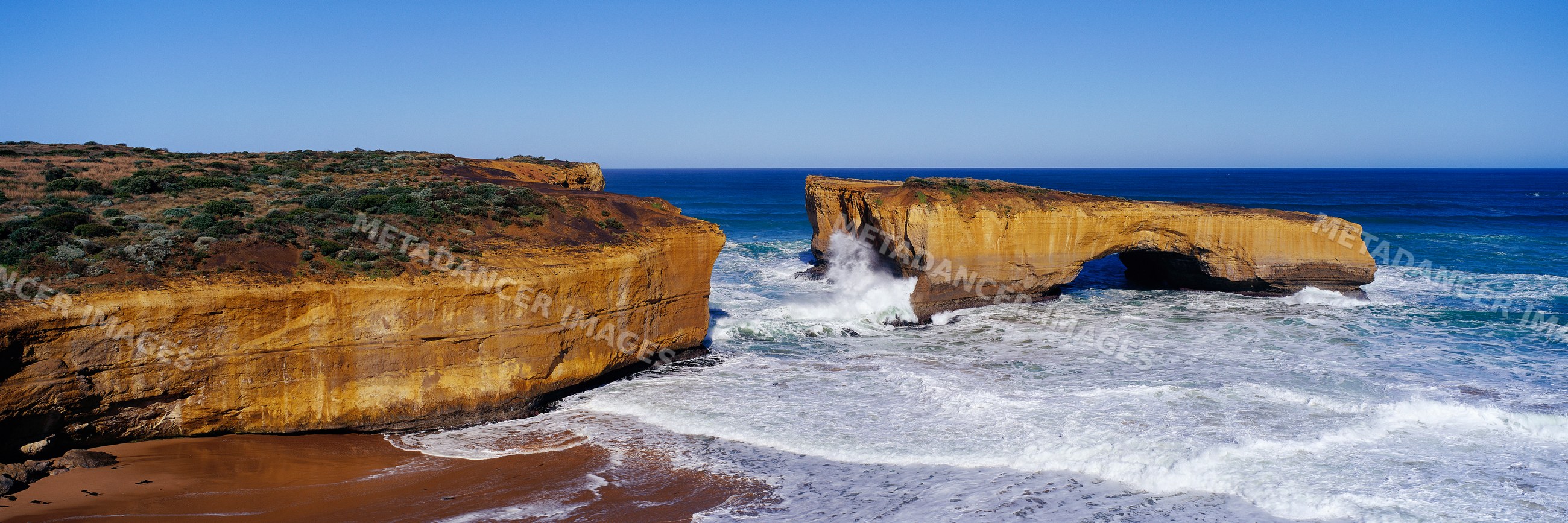 London bridge rock formation with ocean waves victoria australia