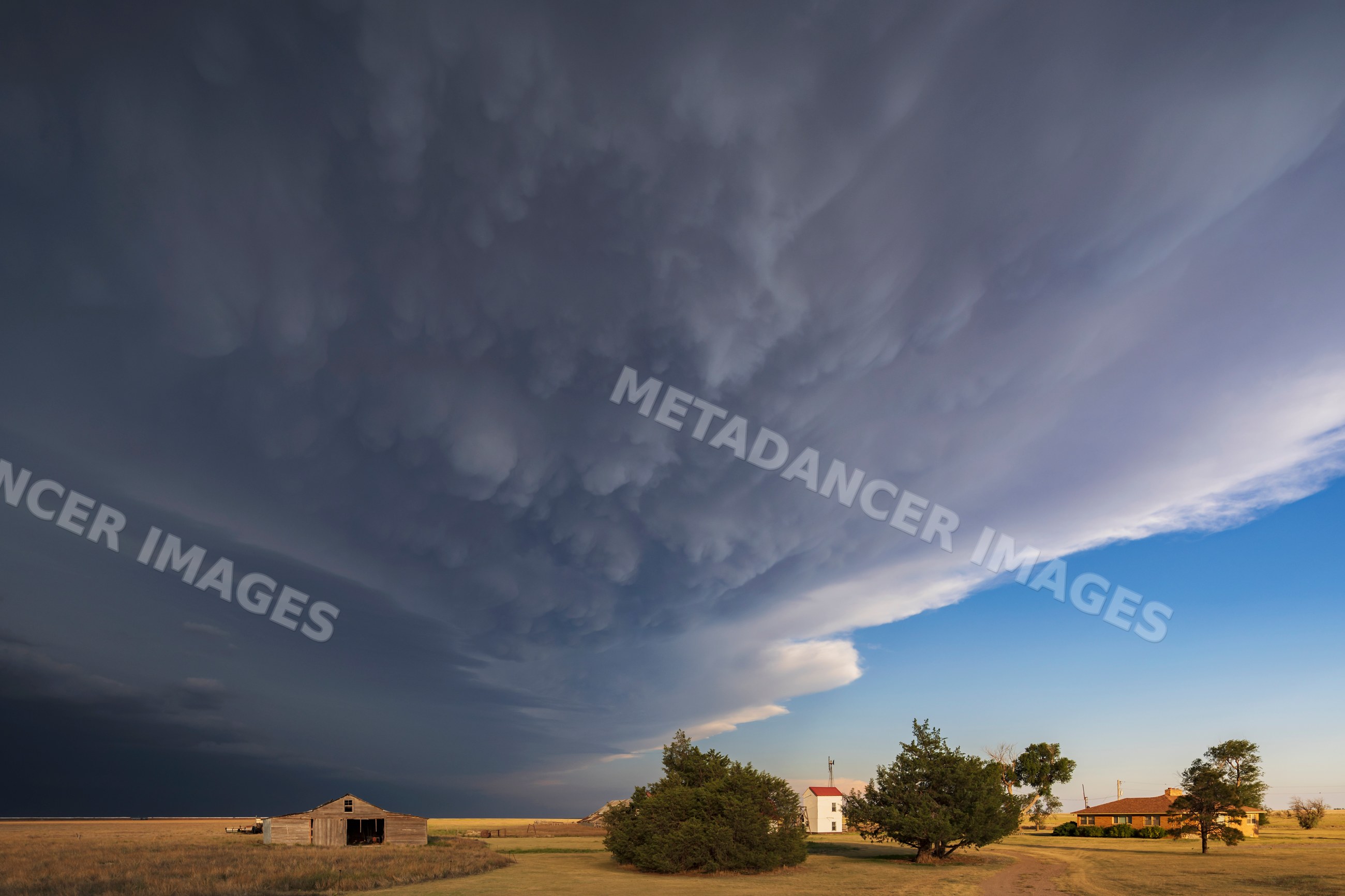 Storm clouds approaching homestead near johnson city kansas USA