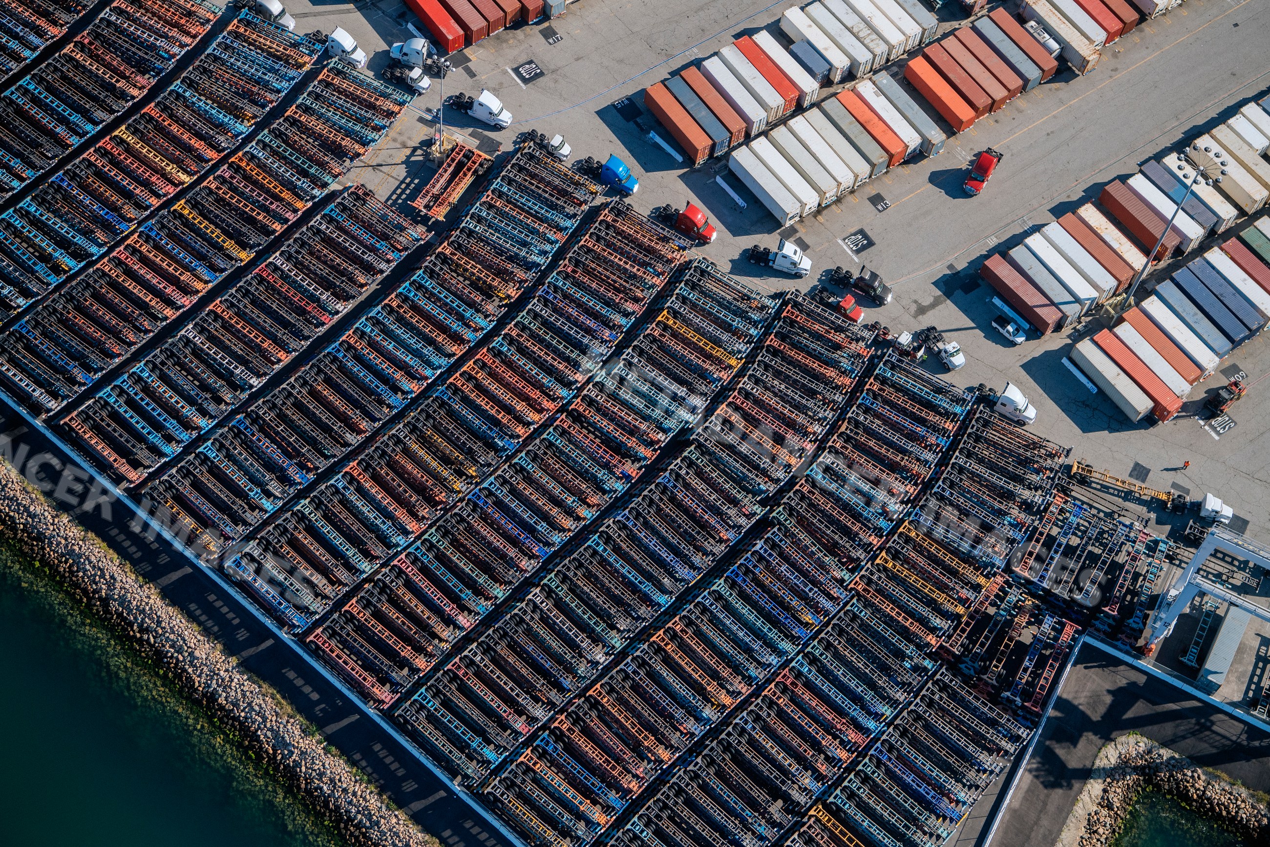 Container chassis and truck trailers parked at port parking lot