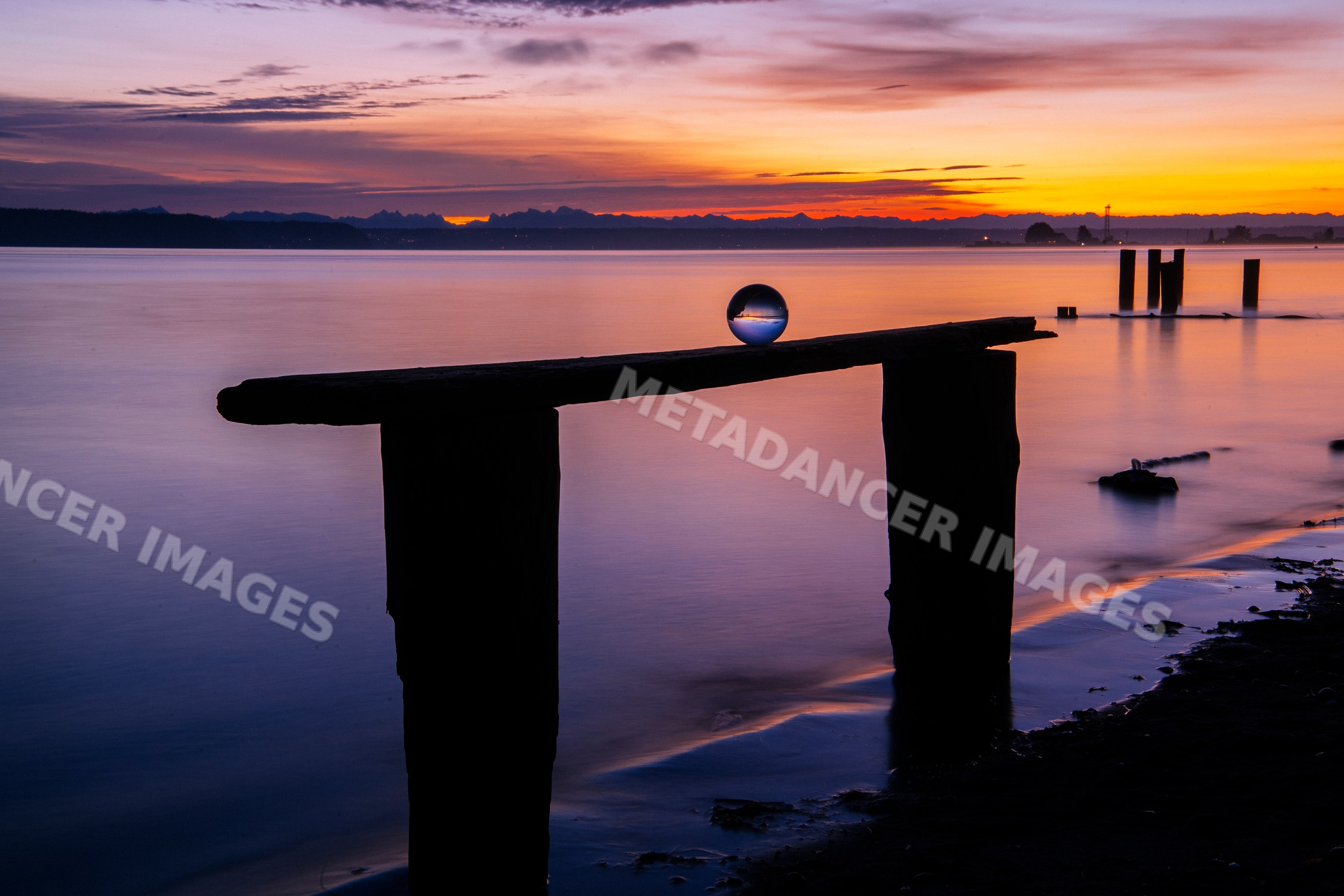 Sunset at Norwegian Point with wooden pier and crystal ball reflection
