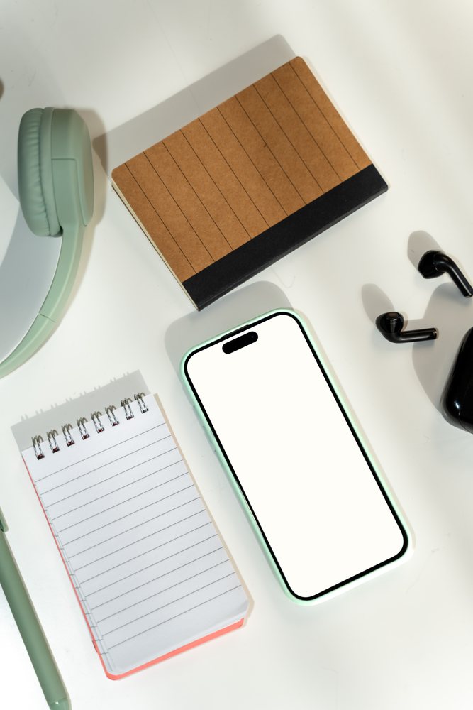 Smartphone and office supplies on white background in a office