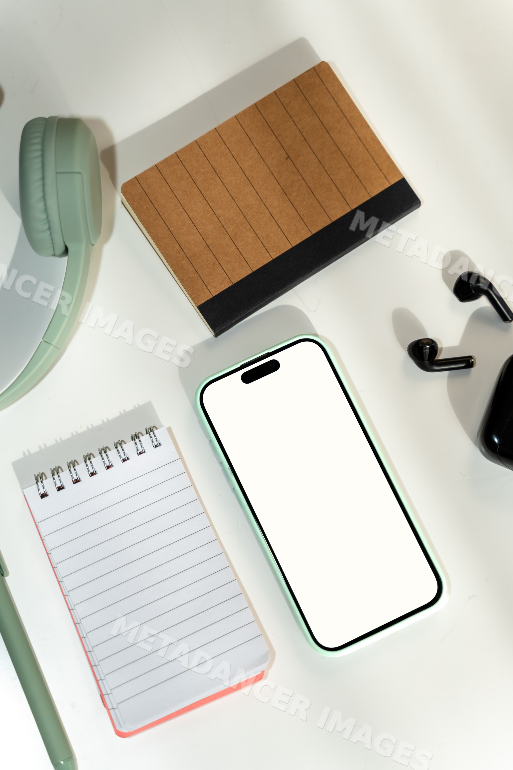 Smartphone and office supplies on white background in a office