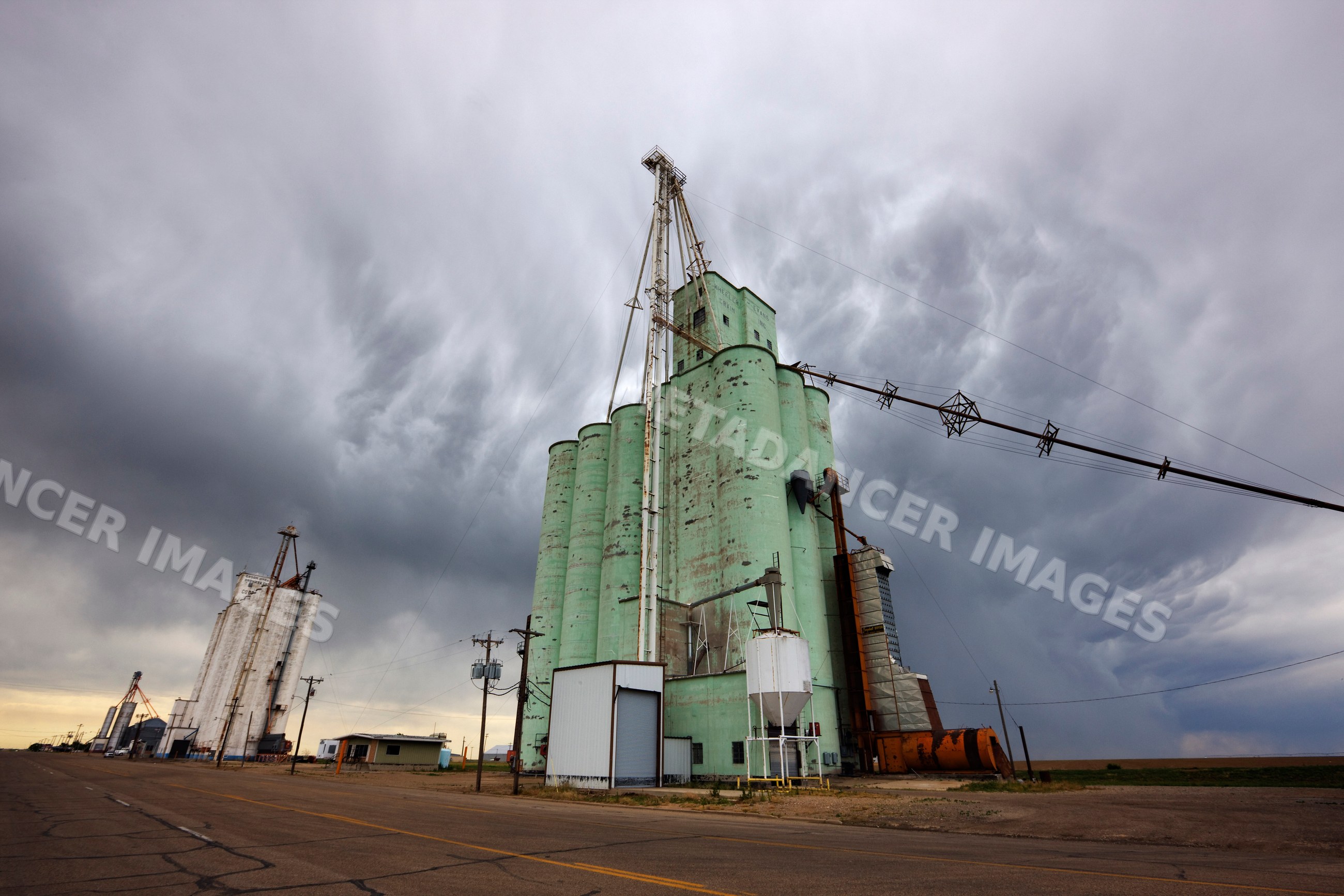 Grain elevators with storm clouds, texas