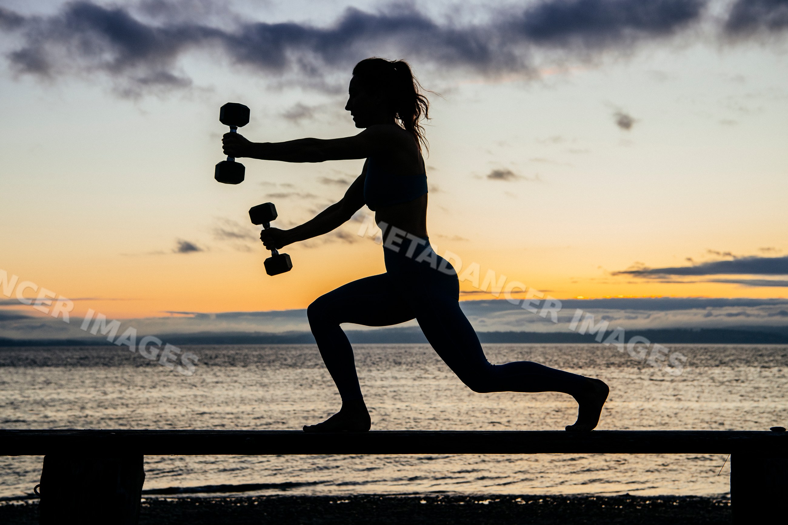 White woman exercising with dumbbells