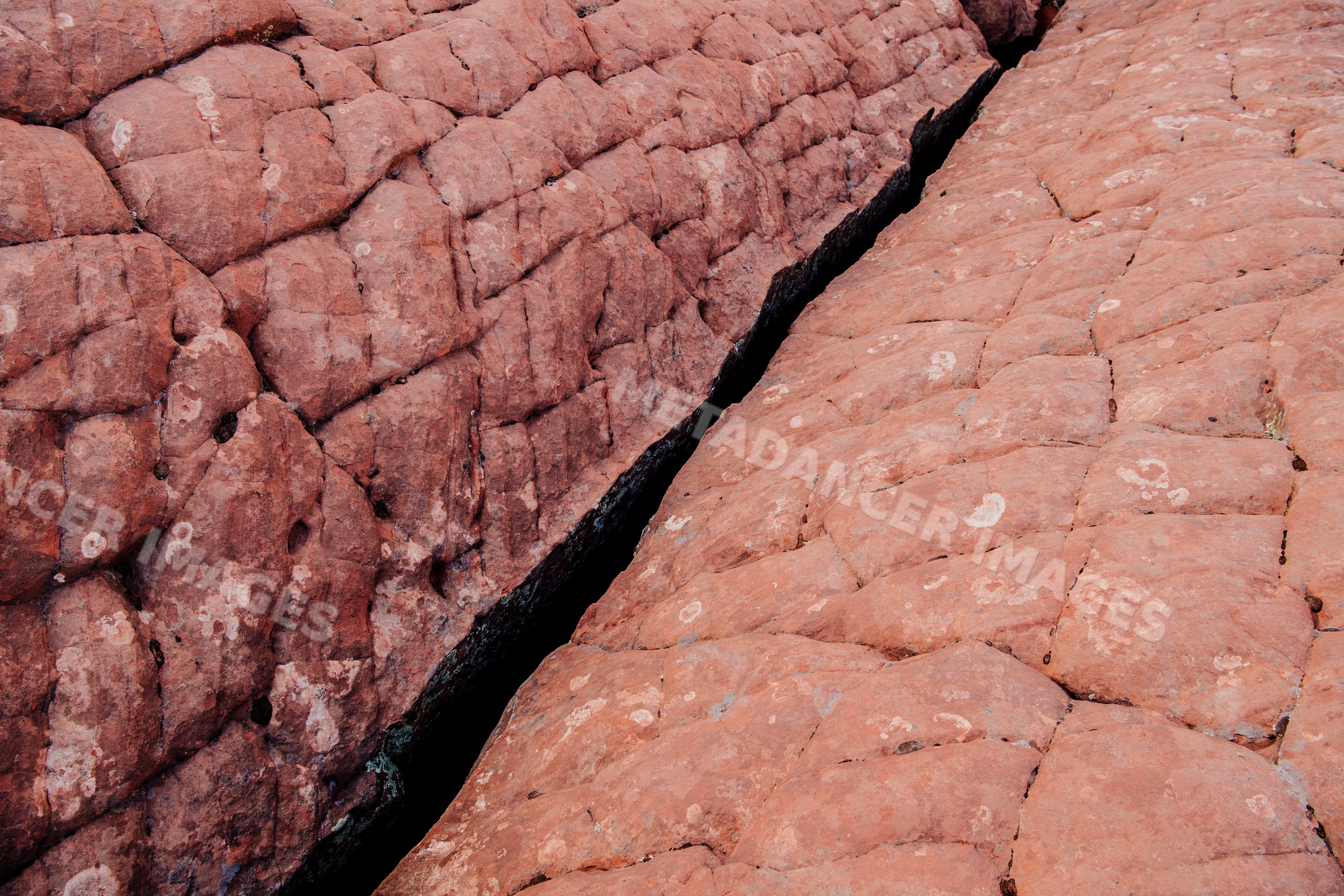 Red rock formation with crack desert terrain