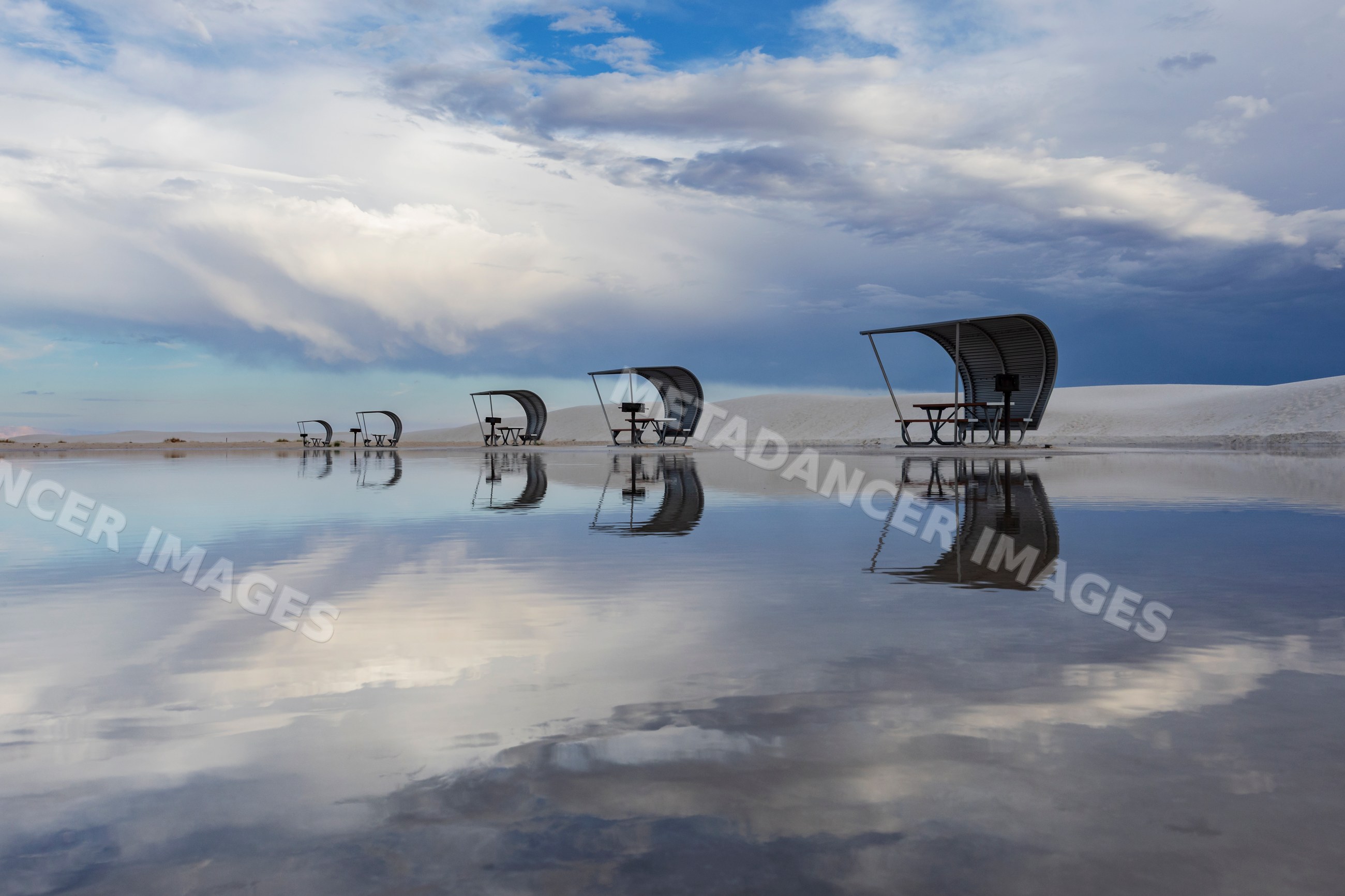 Cabanas reflected in flooded amphitheatre at white sands desert