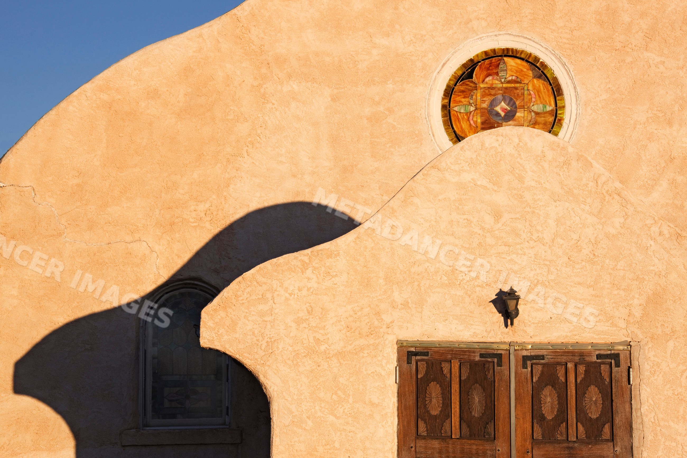 Church with adobe architecture and stained glass windows