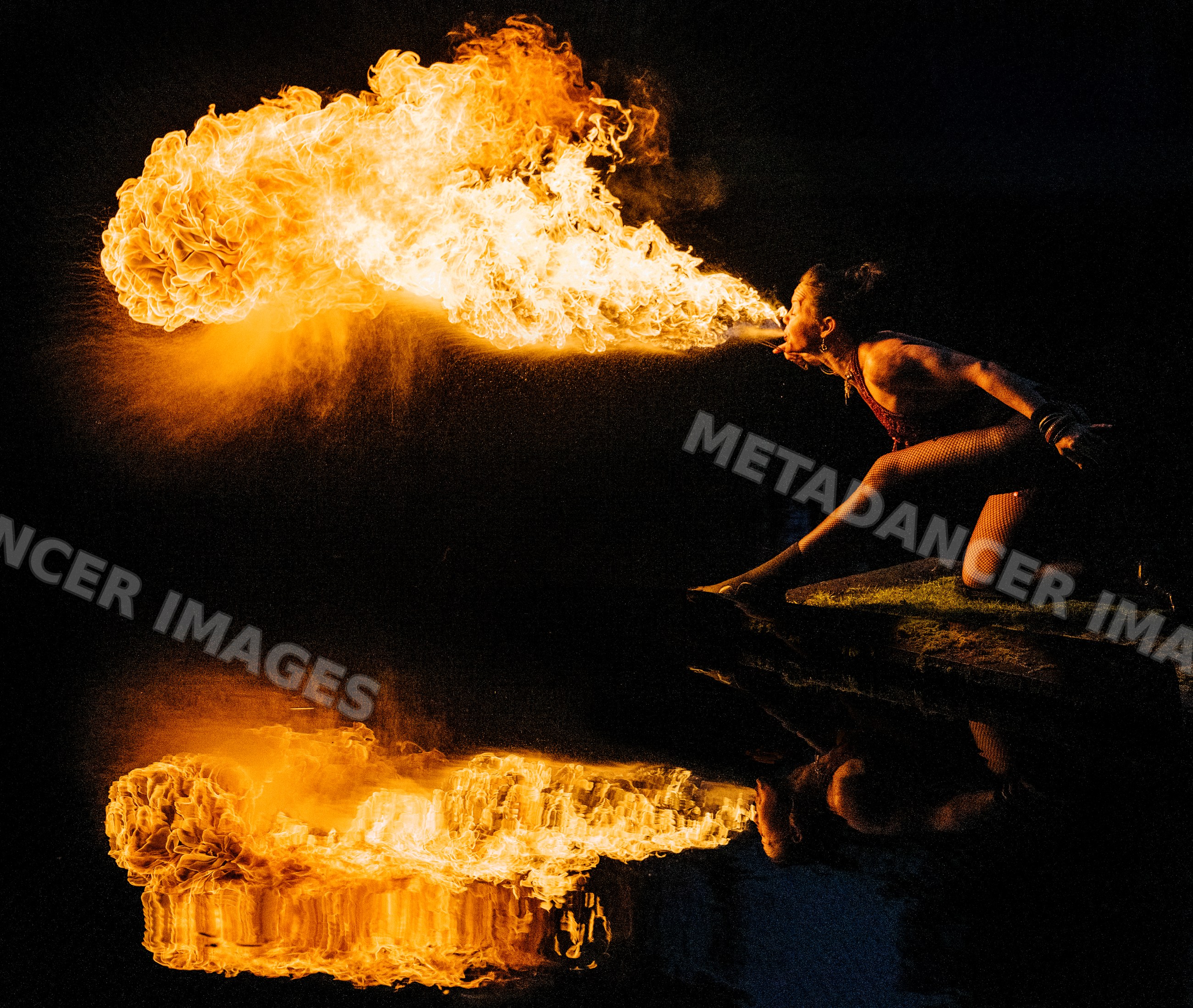 Fire African American performer breathing fire with dramatic
