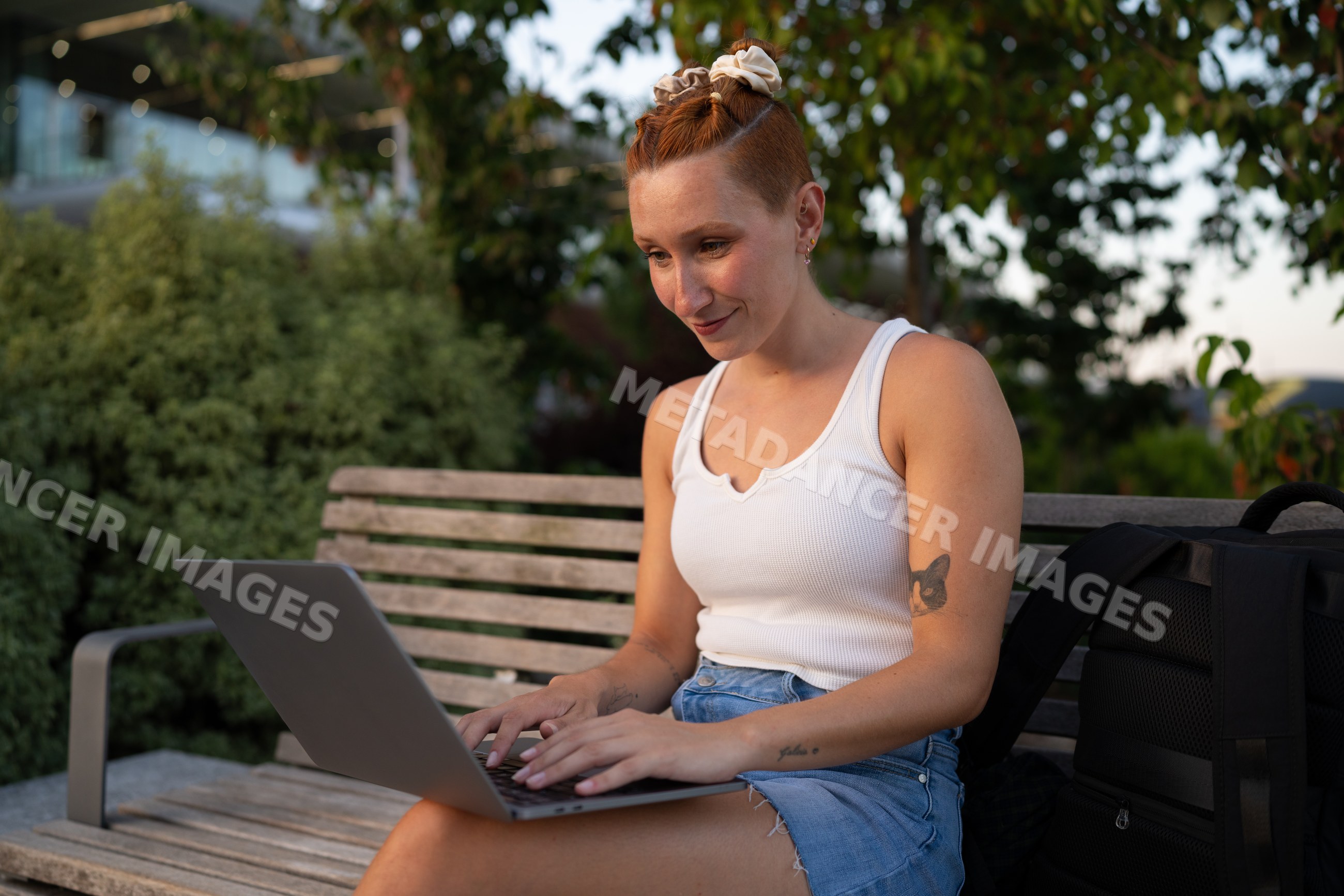 A white woman works on her laptop