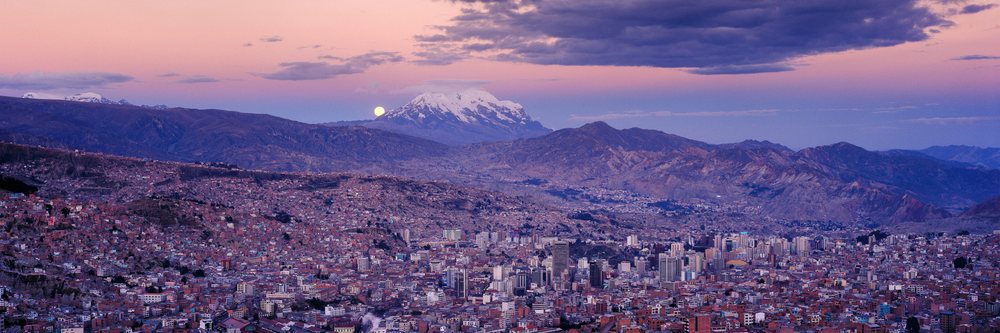 La paz cityscape with volcano illimani at dusk