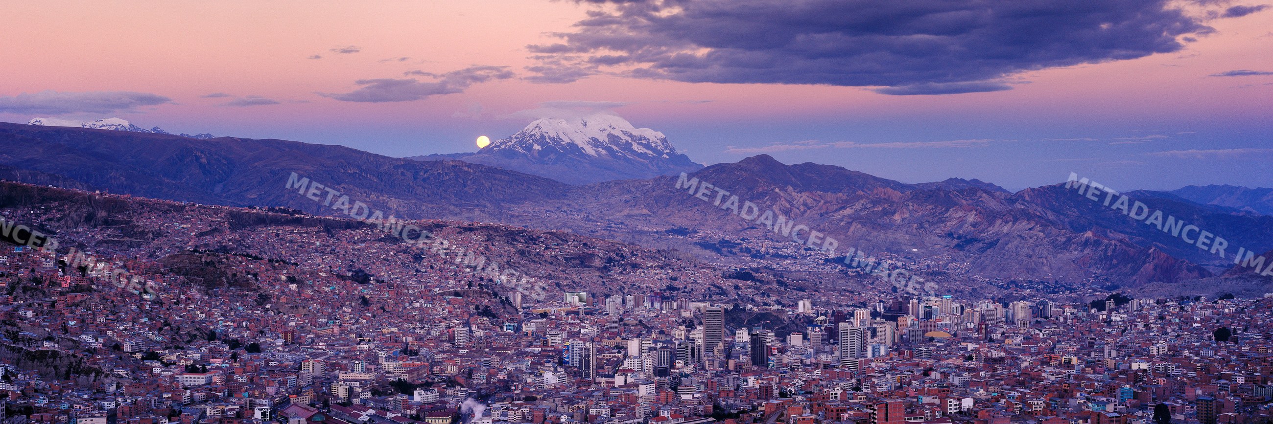 La paz cityscape with volcano illimani at dusk