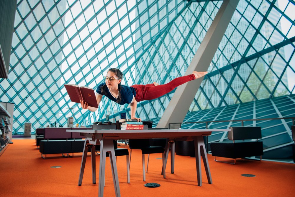 A woman reading a book balancing