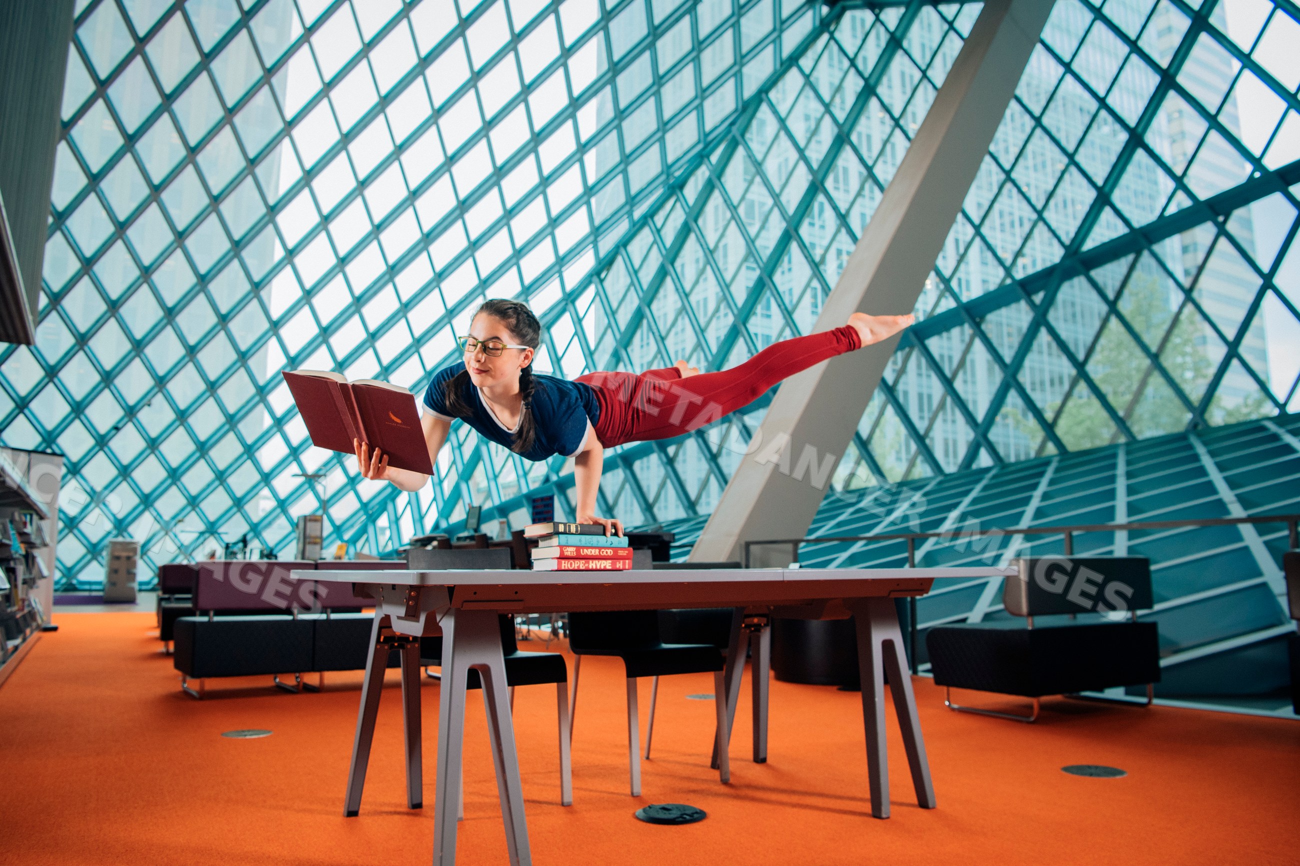A woman reading a book balancing