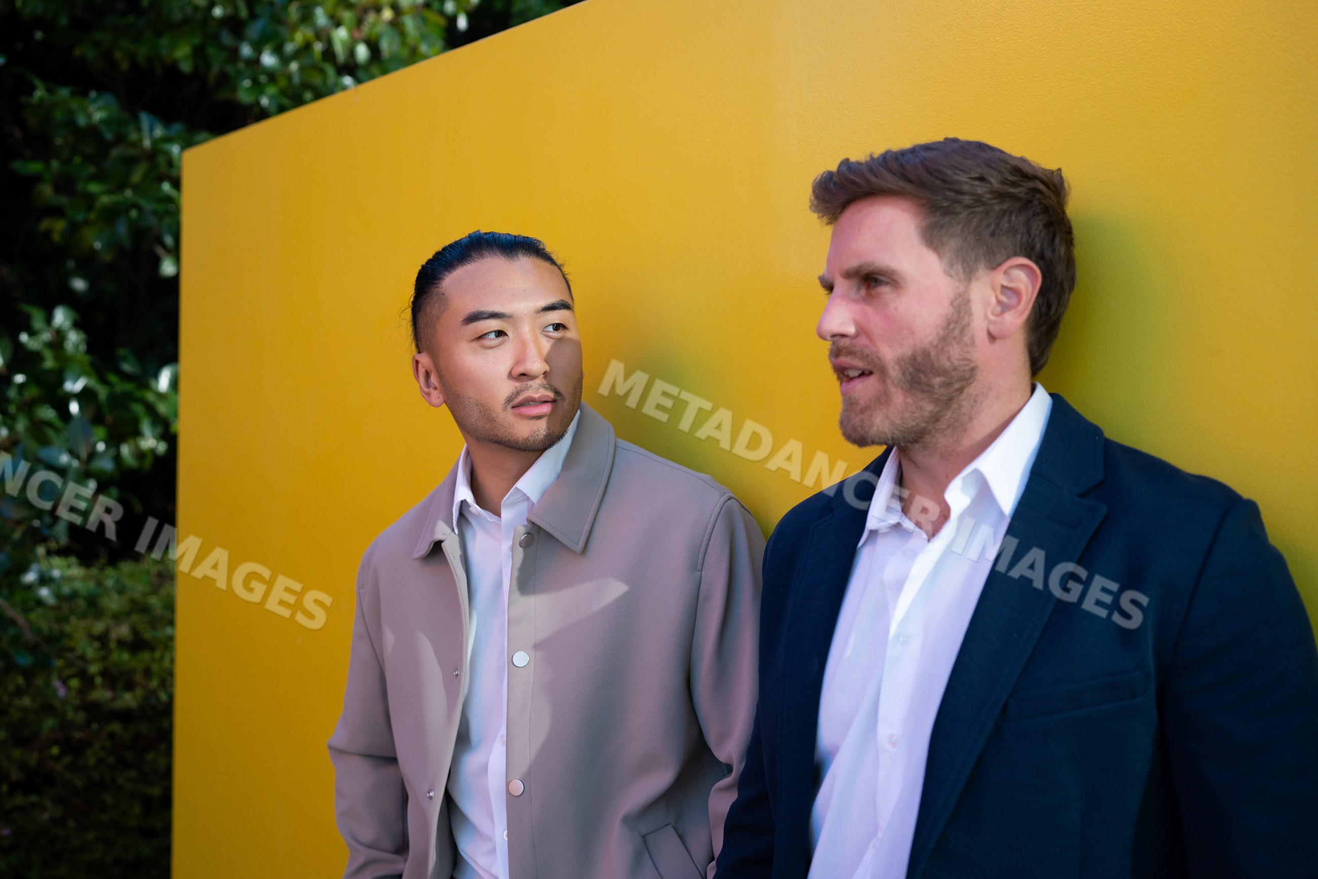 Two white men conversing outdoors