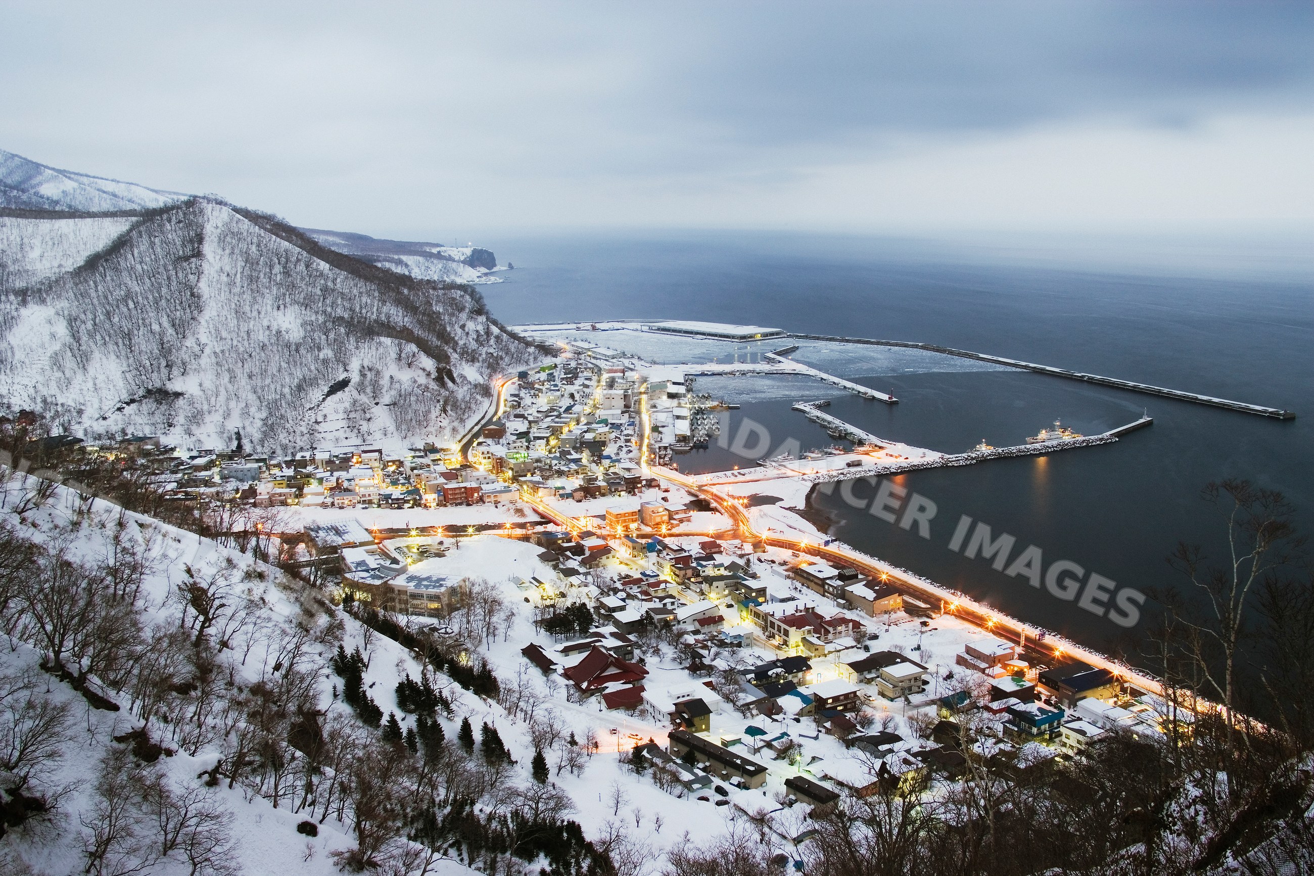 Rausu coastal town at winter dusk on shiretoko peninsula, hokkaido