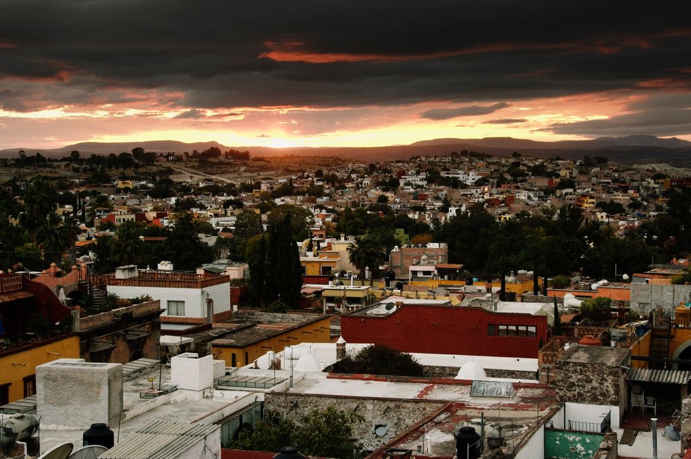 Sunset over san miguel de allende rooftops and hills