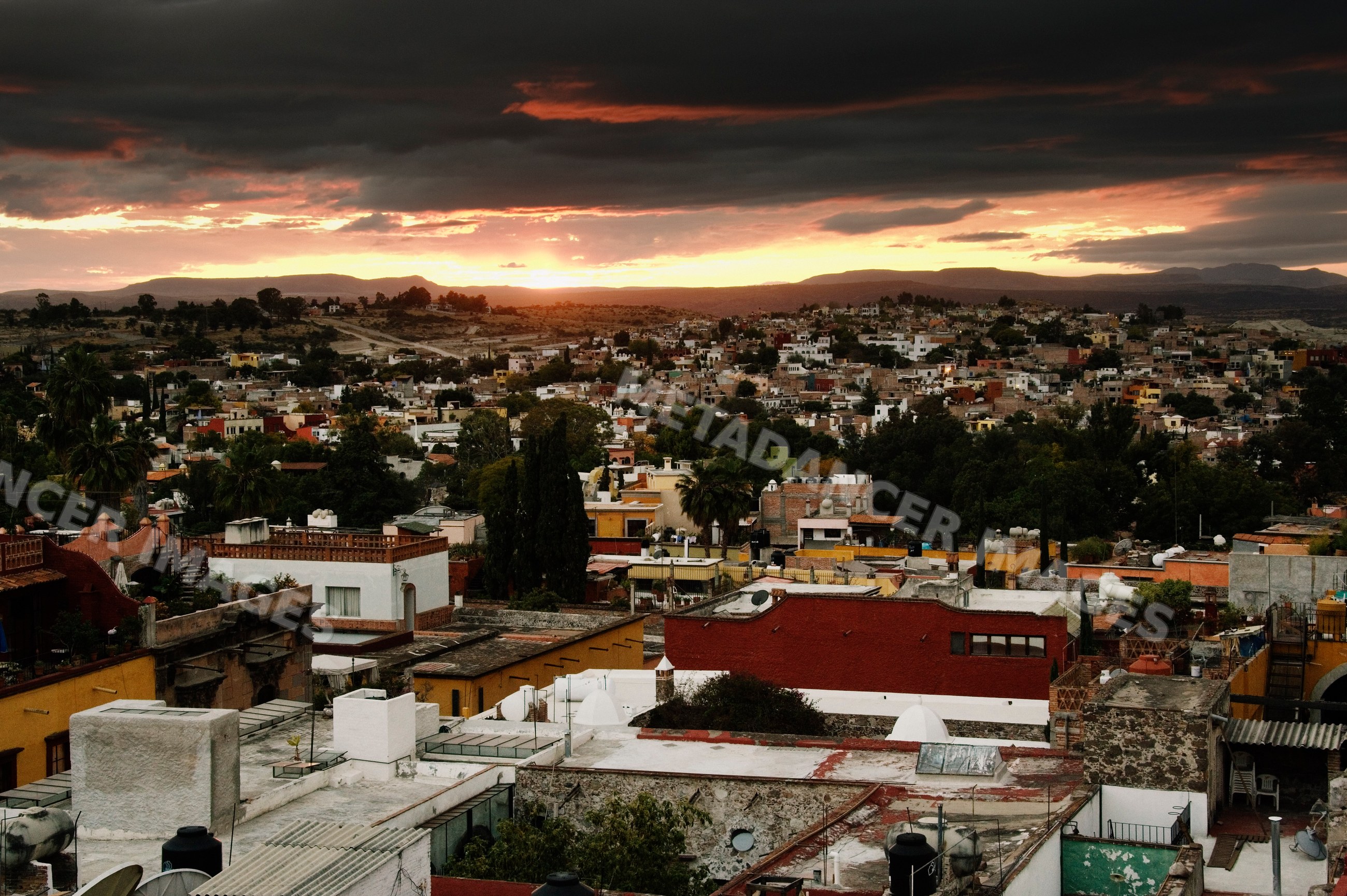 Sunset over san miguel de allende rooftops and hills