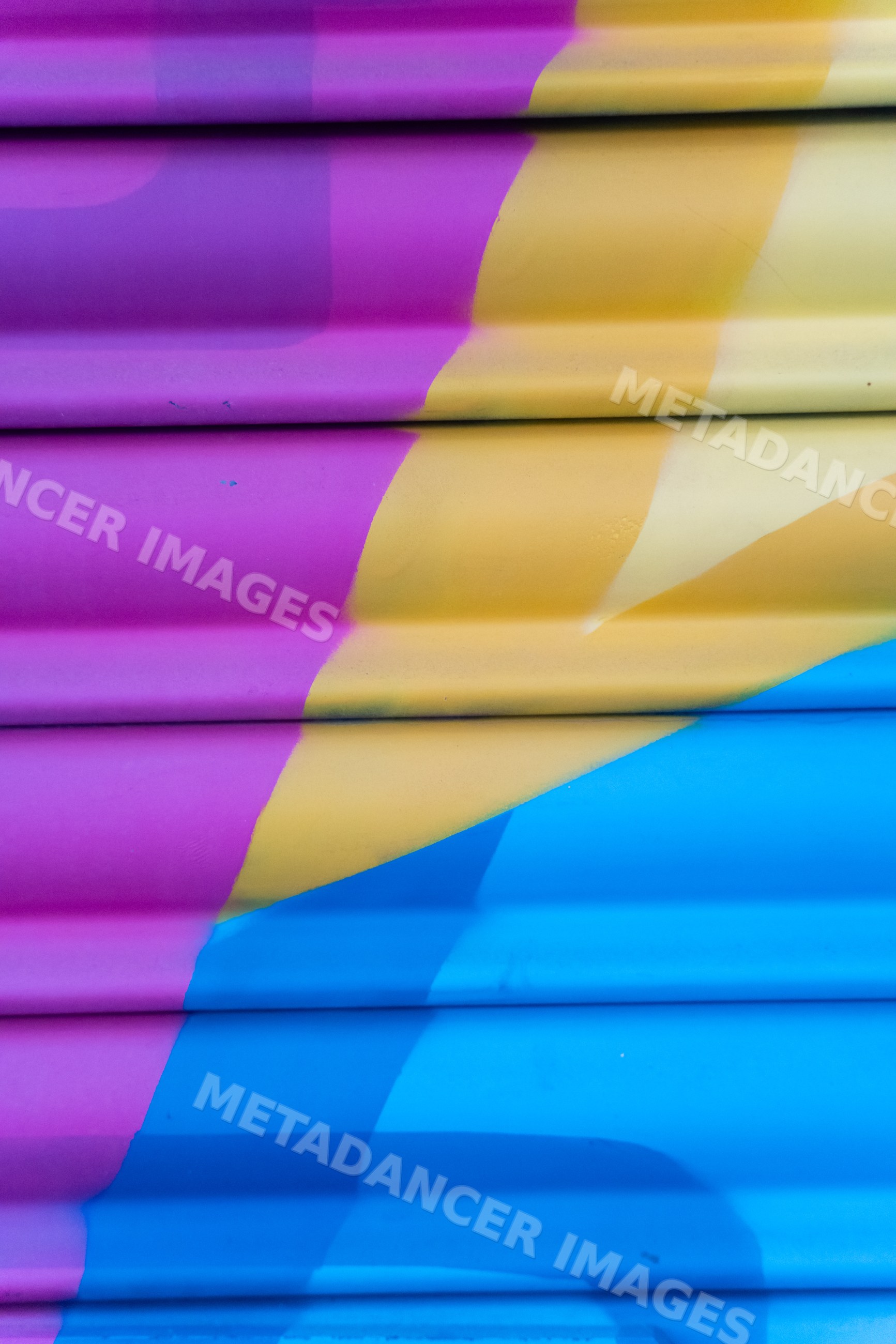 Abstract colorful paint texture on corrugated metal surface