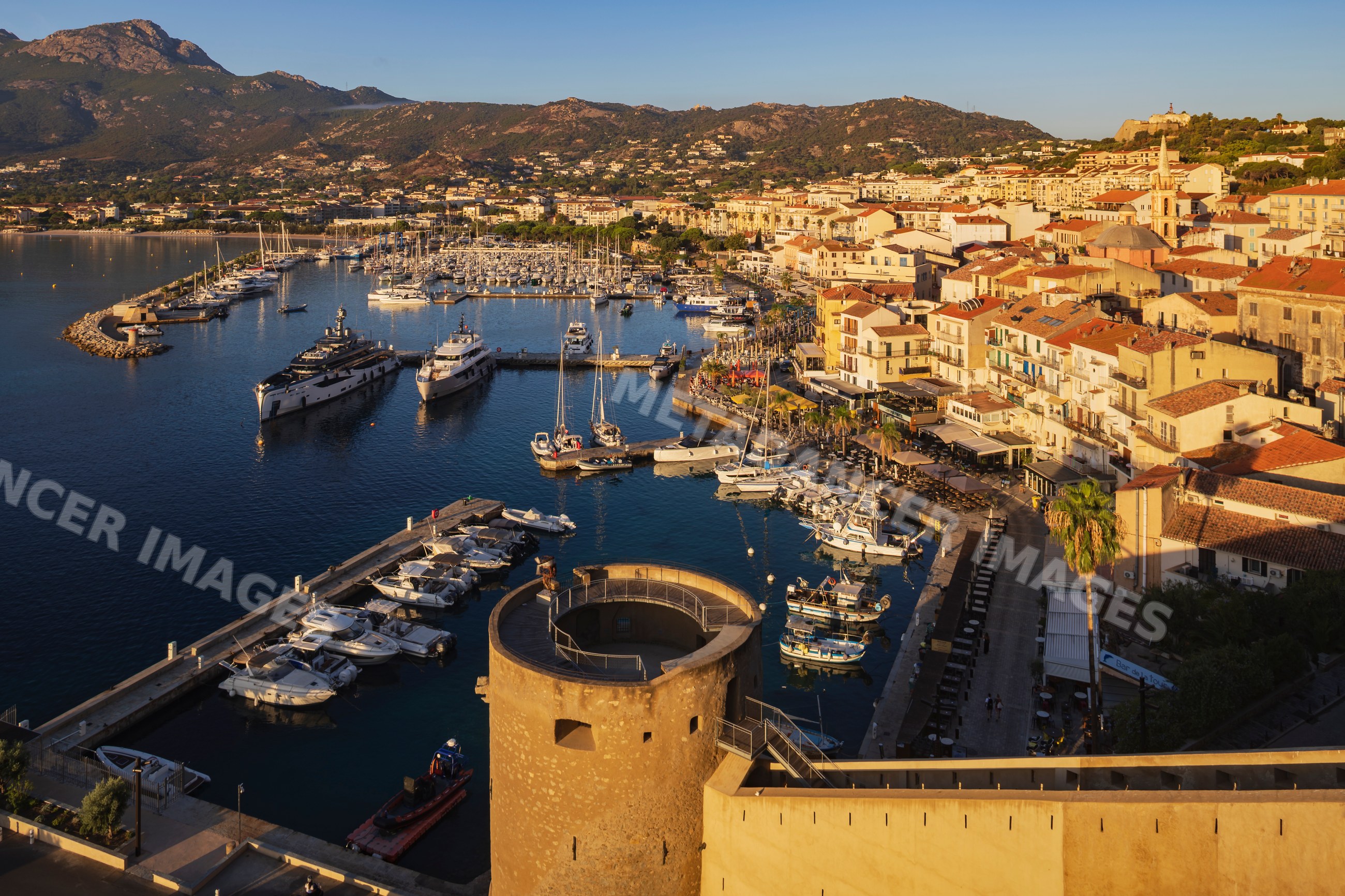 Harbour at Calvi with boats and cityscape in corsica, france