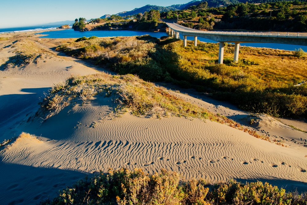 Bridge over river with sand dunes in northern Oregon and California