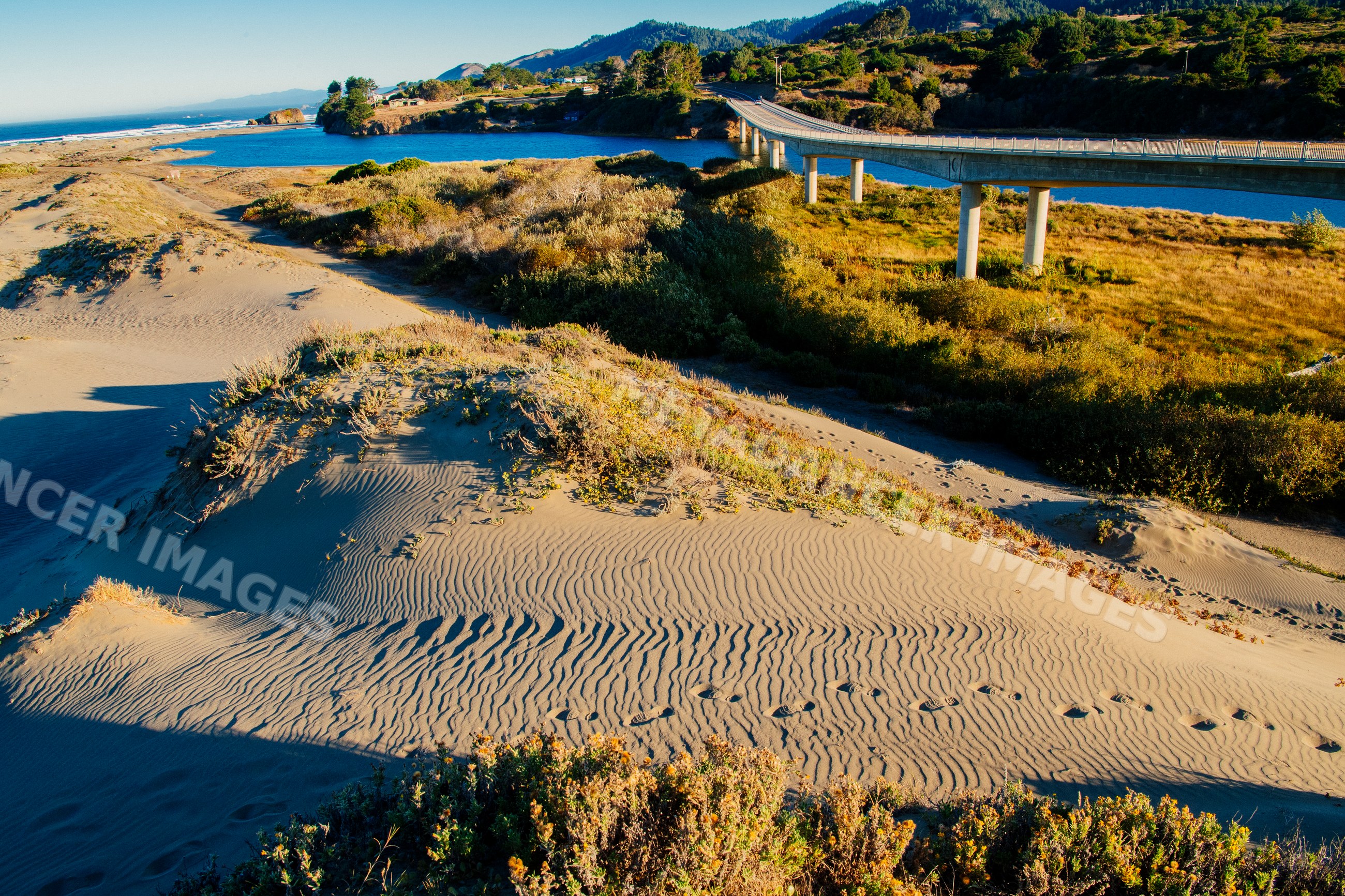 Bridge over river with sand dunes in northern Oregon and California