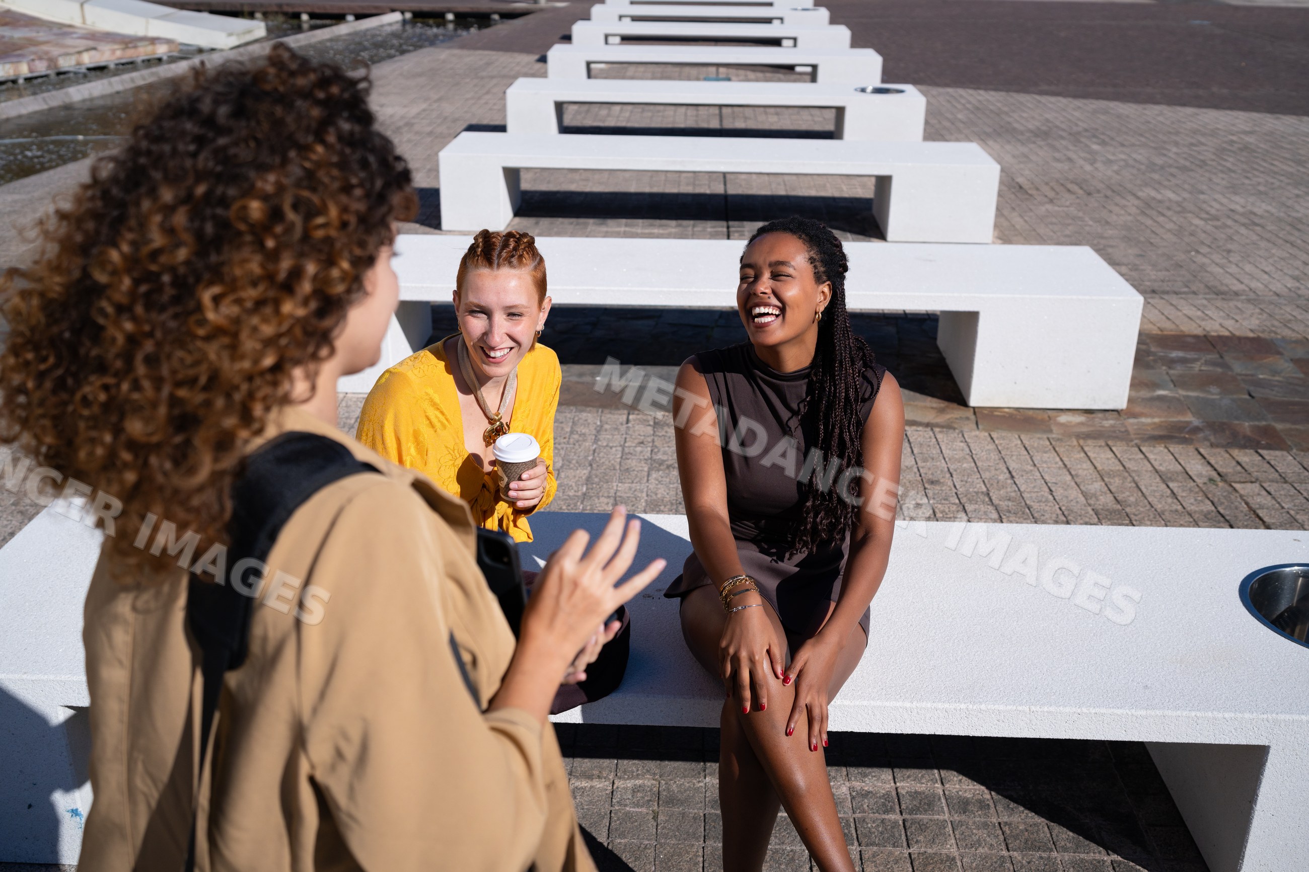 African American and white women laughing and chatting