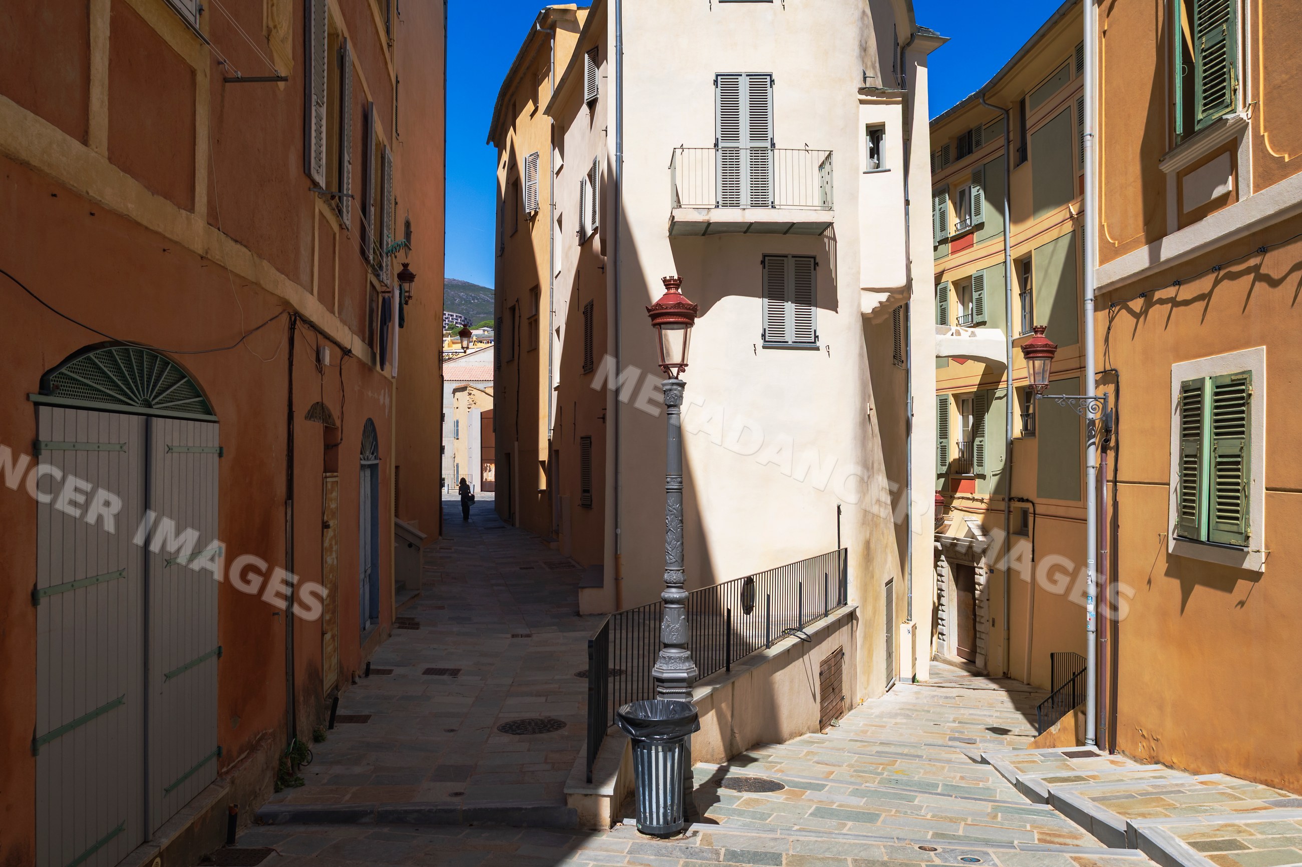Narrow street with shutters in bastia, corsica, france