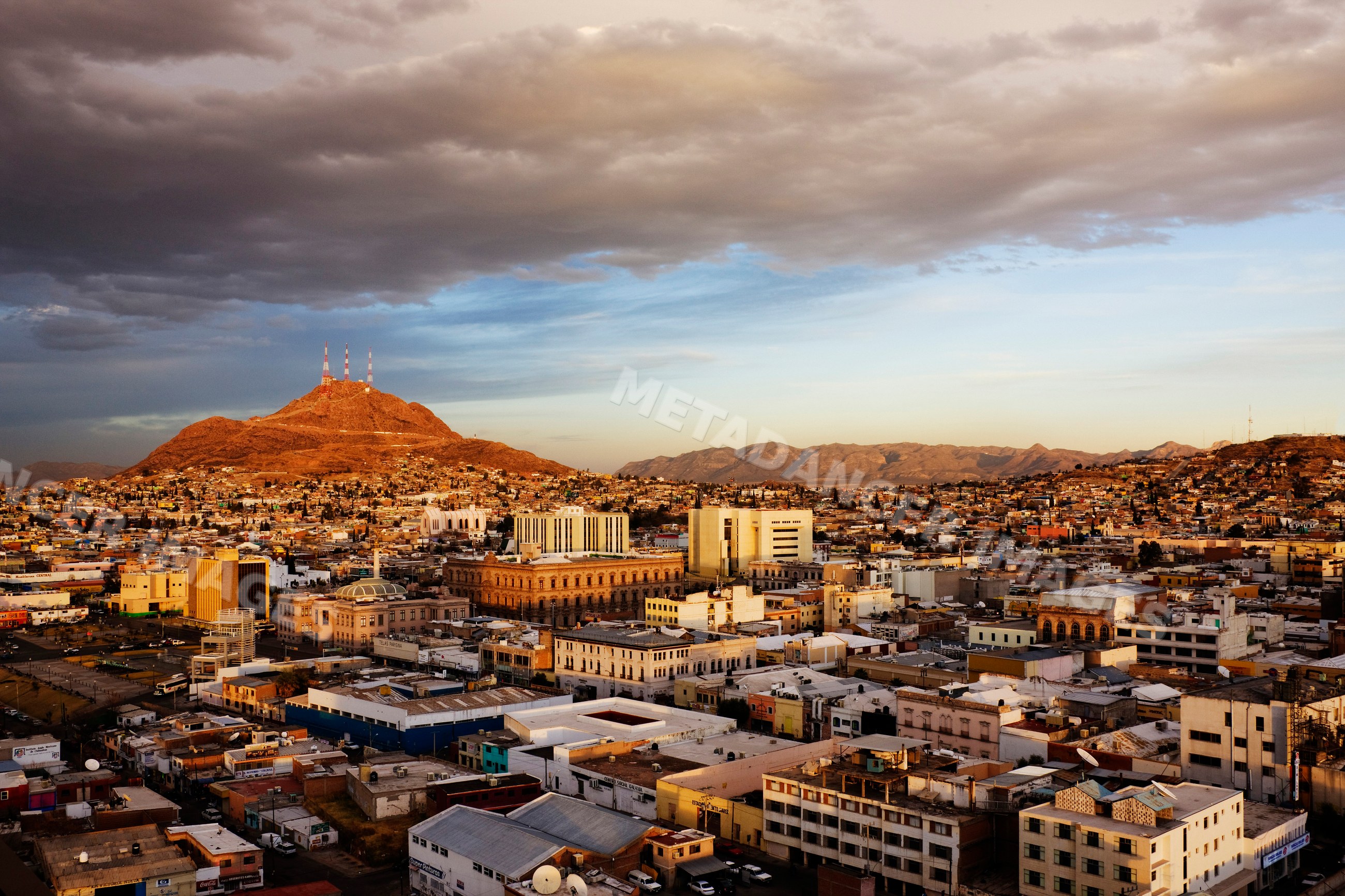 Cityscape of chihuahua, mexico with mountain and communication towers