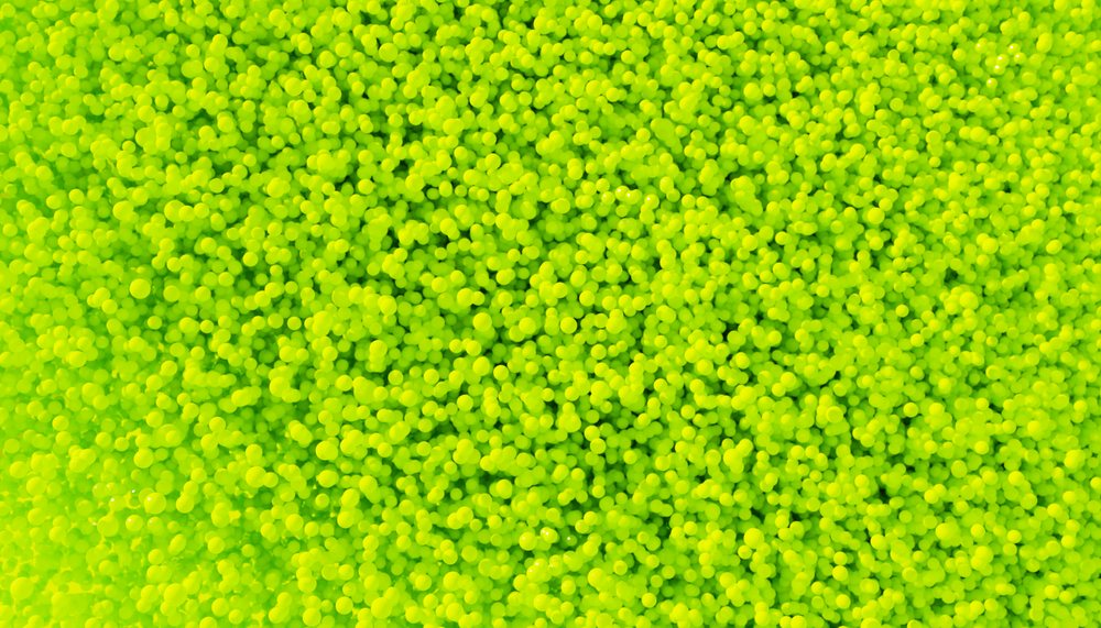Close-up of a vibrant pile of small yellow balls forming a textured