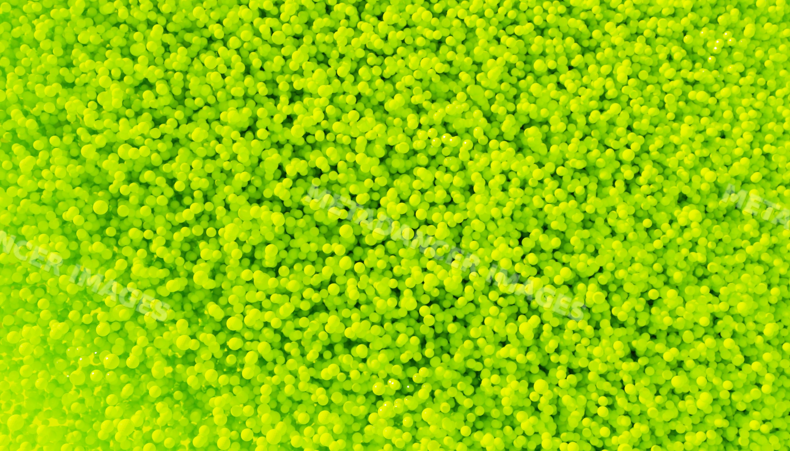 Close-up of a vibrant pile of small yellow balls forming a textured