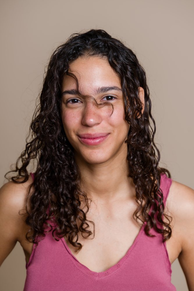 Portrait of smiling Hispanic woman with curly hair