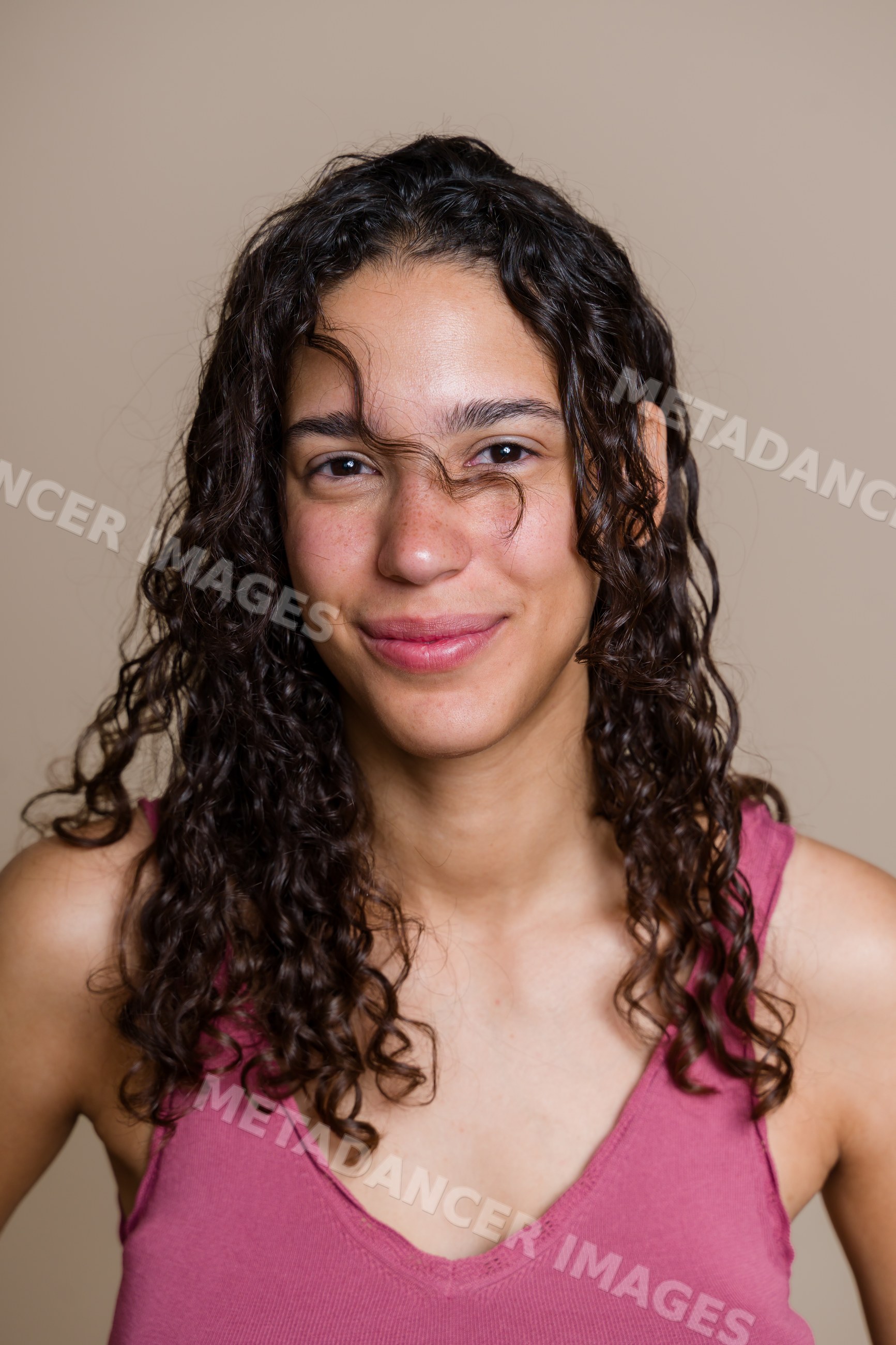 Portrait of smiling Hispanic woman with curly hair
