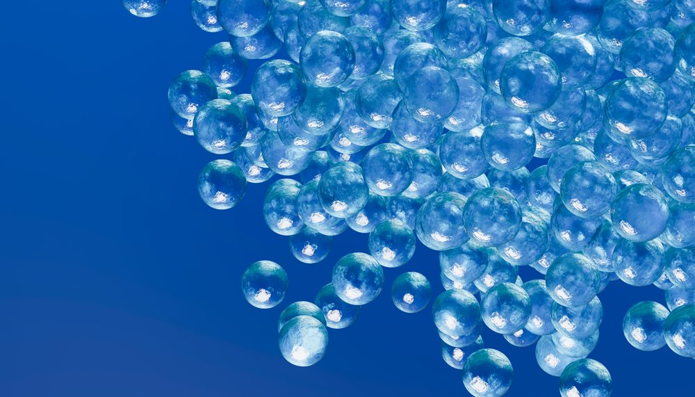 3d digital rendering of transparent blue spheres floating in cluster