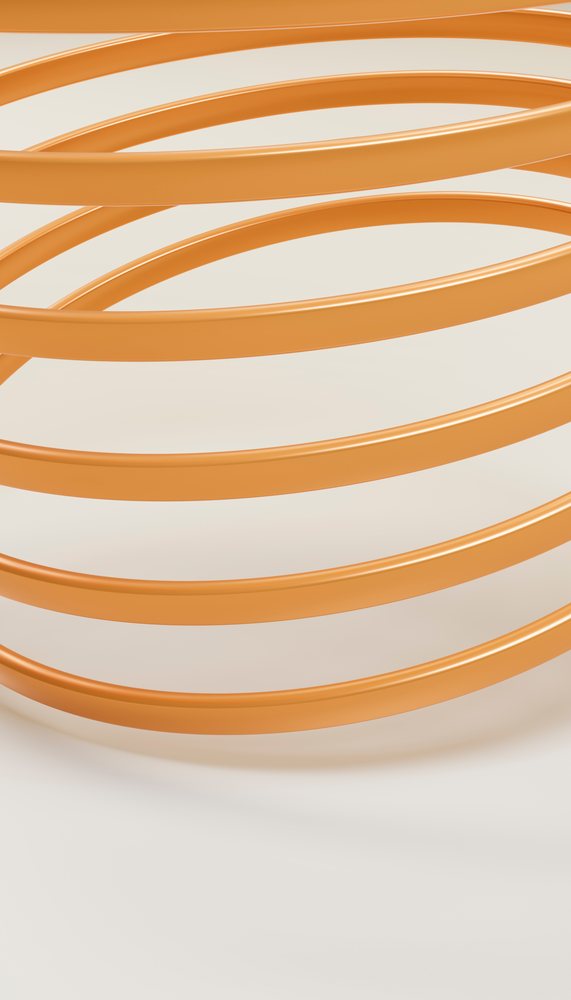 Close-up of orange spiral metal spring with smooth curves