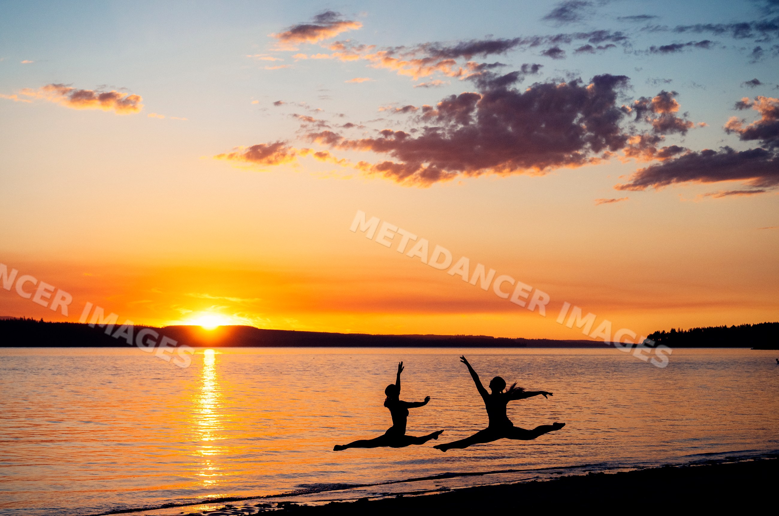 Two individuals jumping in partner acrobatics featuring a white model